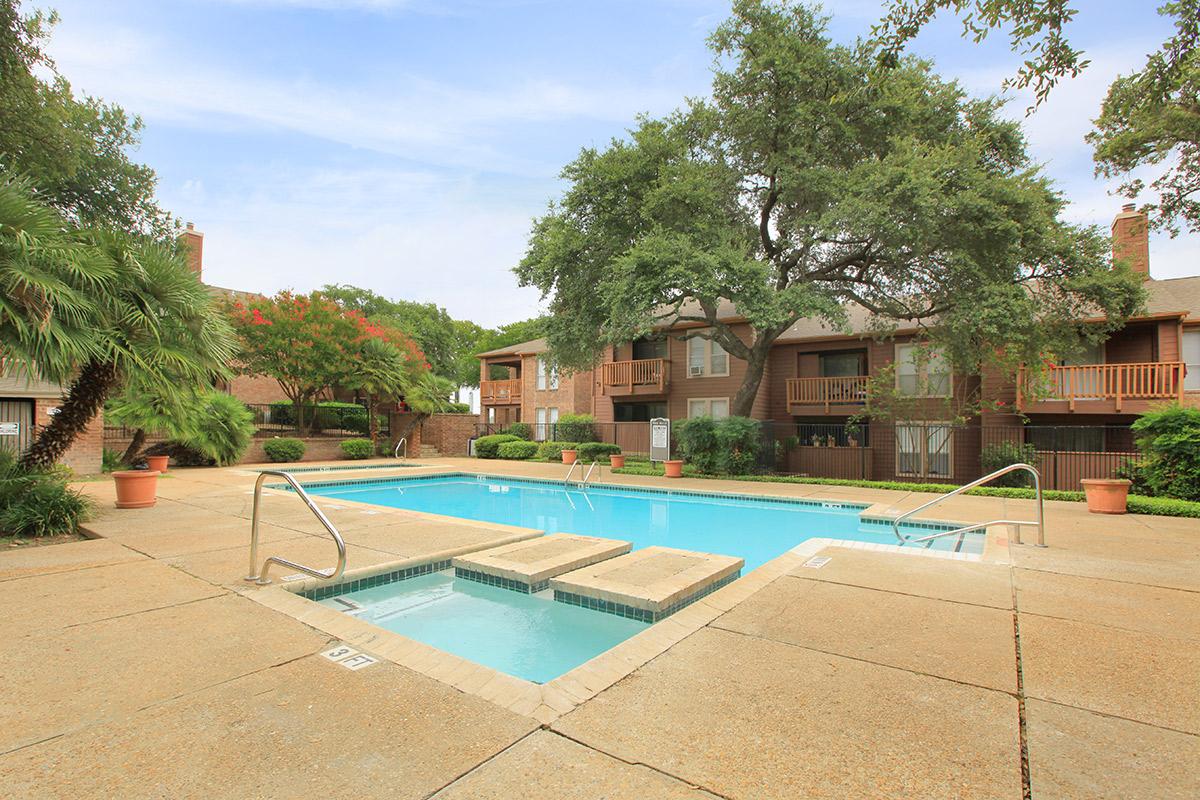 a house with a pool in front of a building