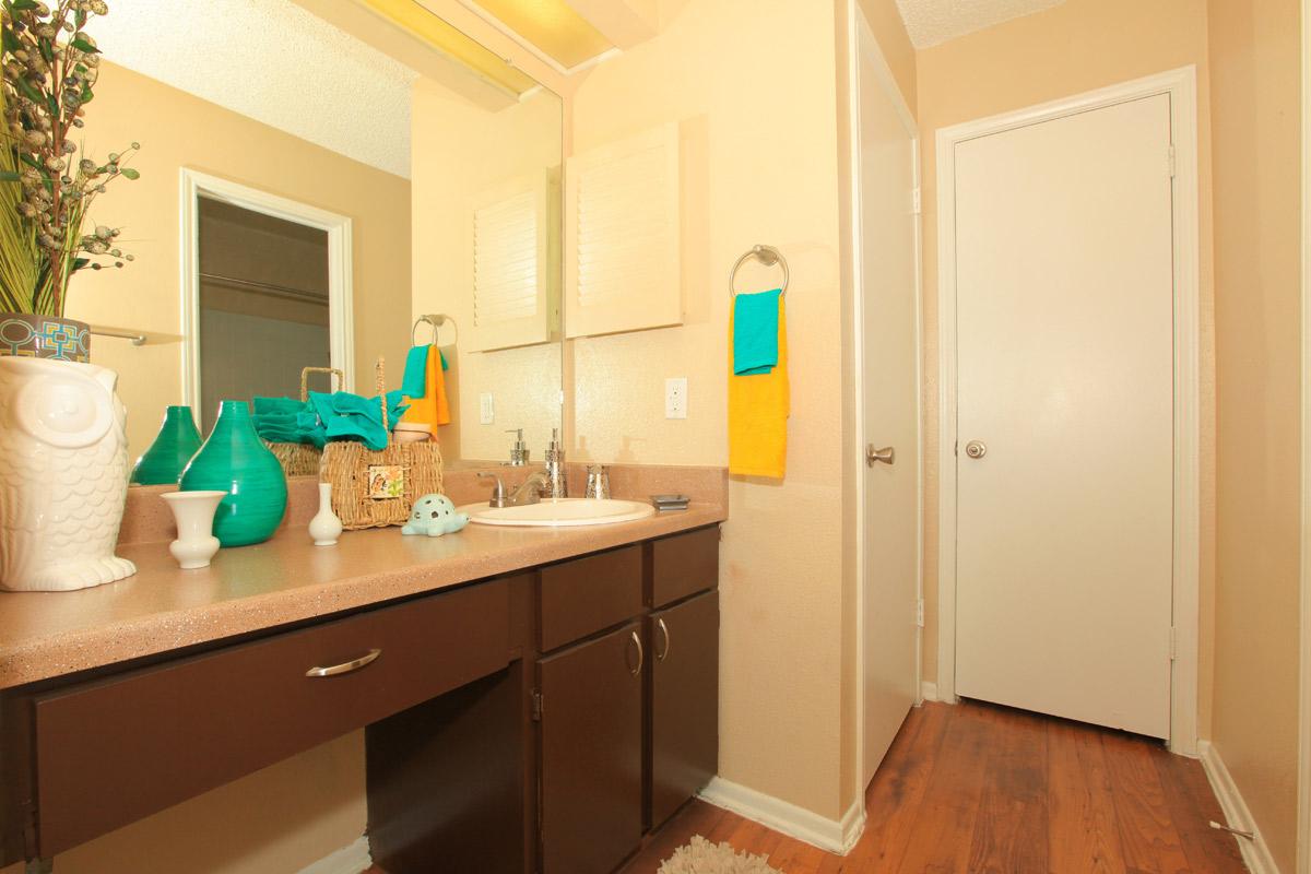 a kitchen with a sink and a mirror