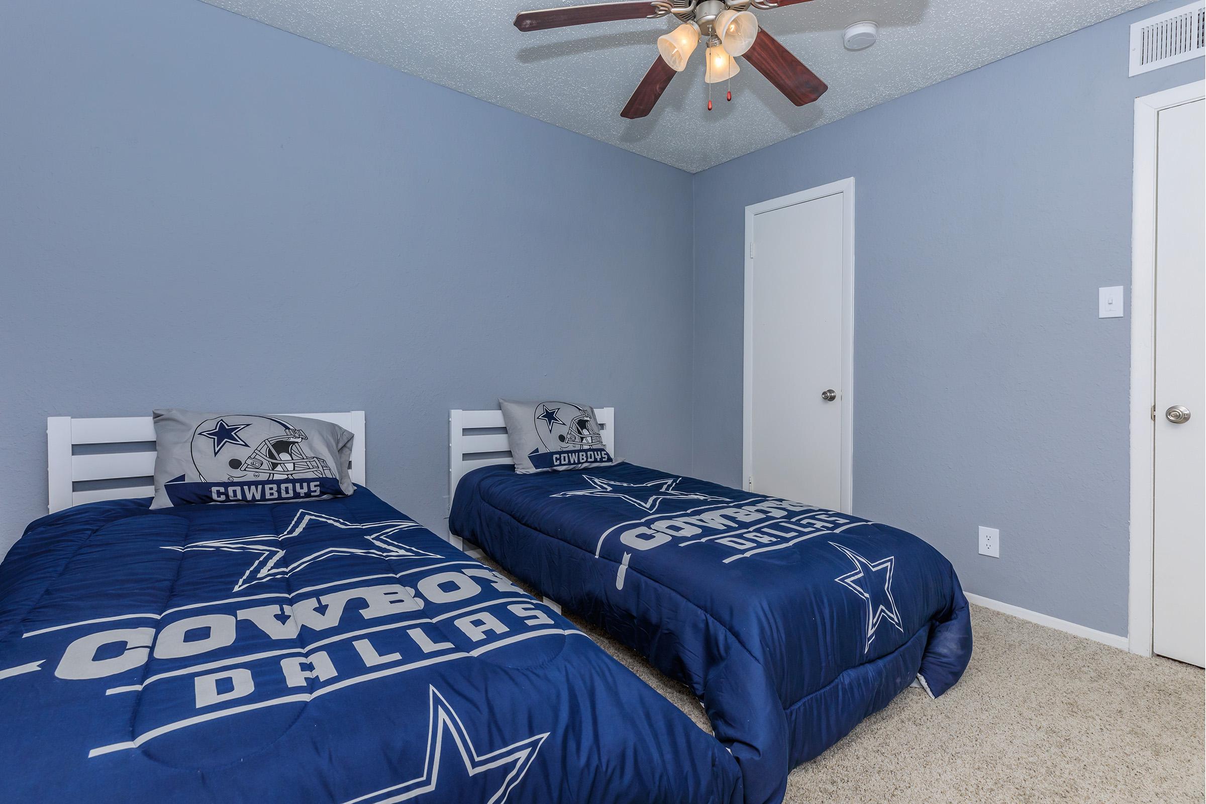 a bedroom with a bed and a blue blanket