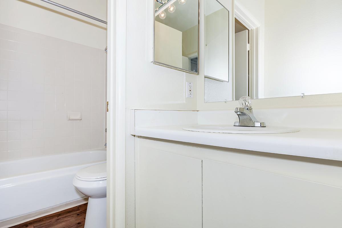 a white tub sitting next to a sink