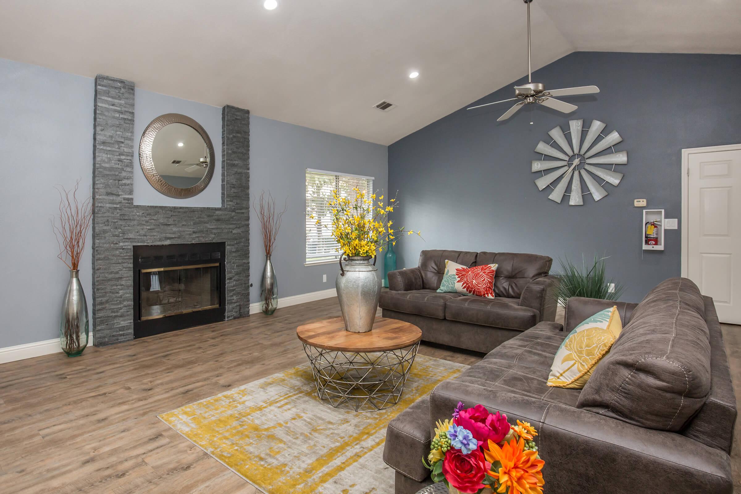 a living room filled with furniture and a fire place