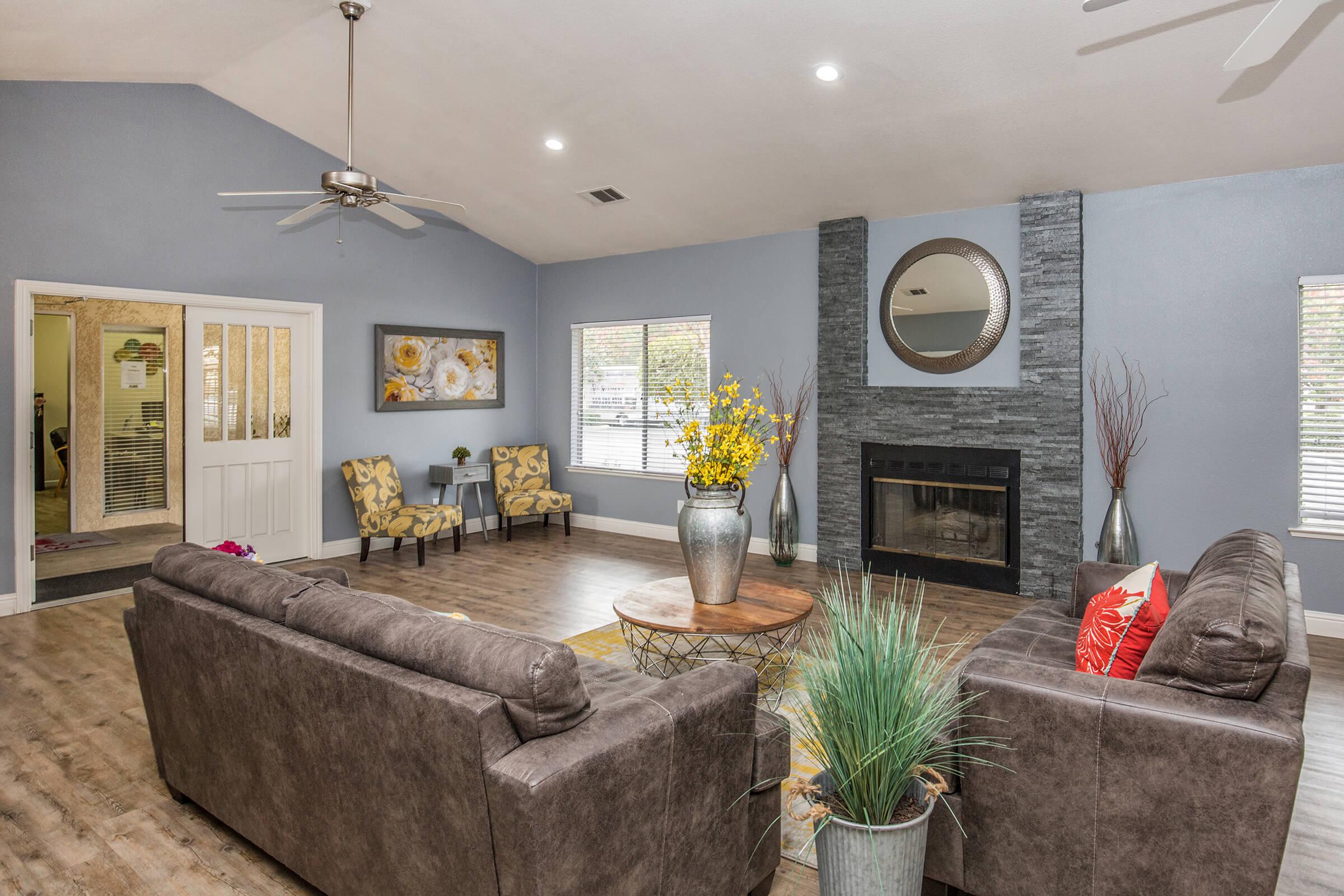 a living room filled with furniture and a fire place