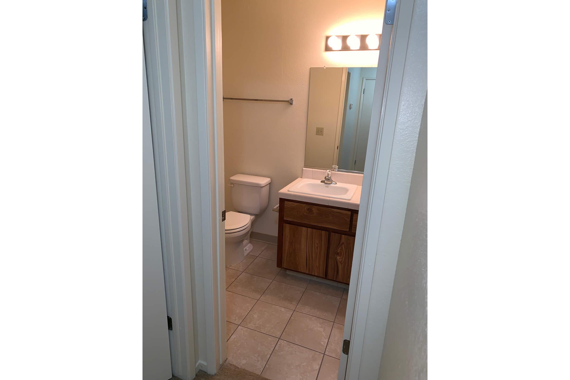 a white sink sitting next to a door