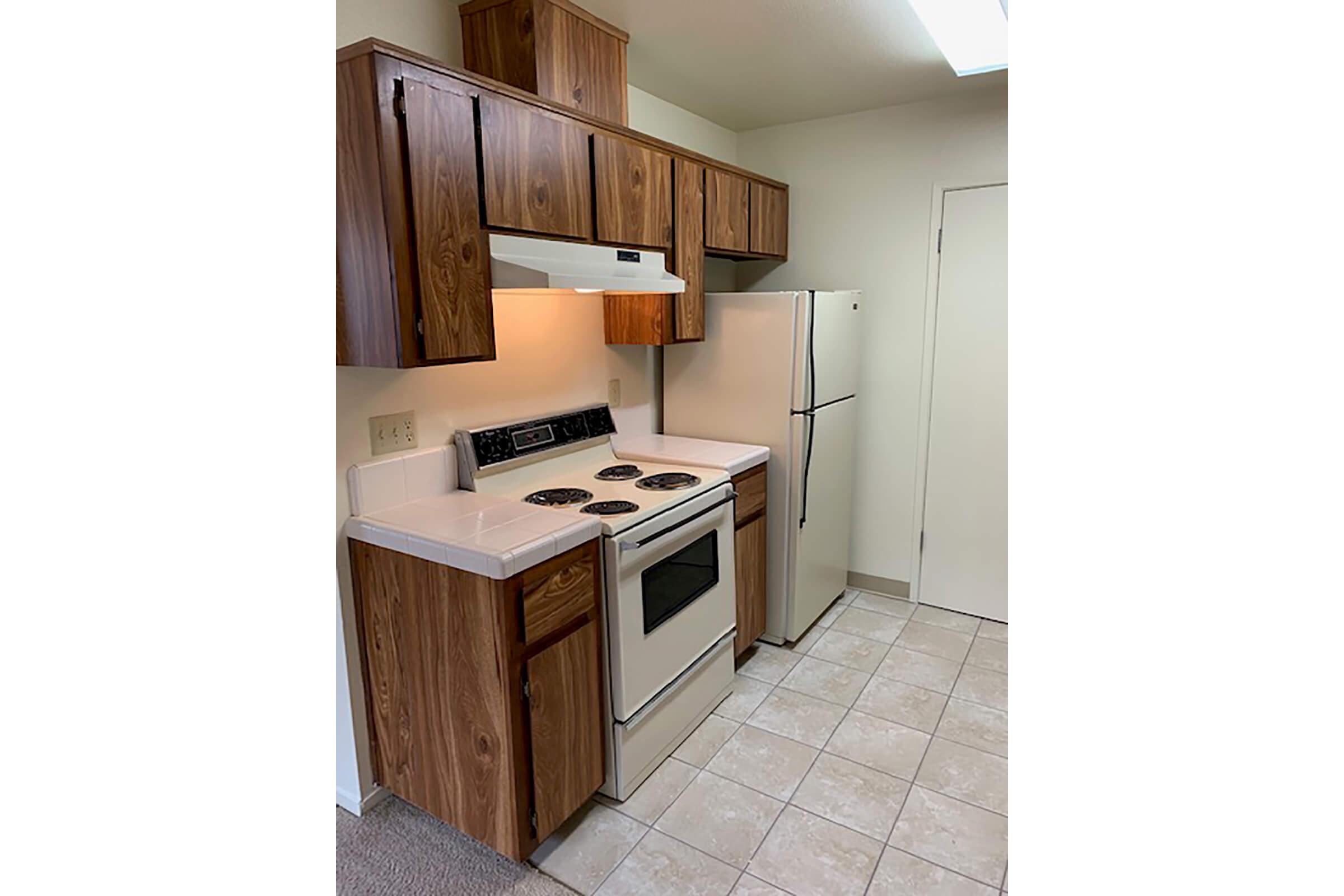 a kitchen with wooden cabinets