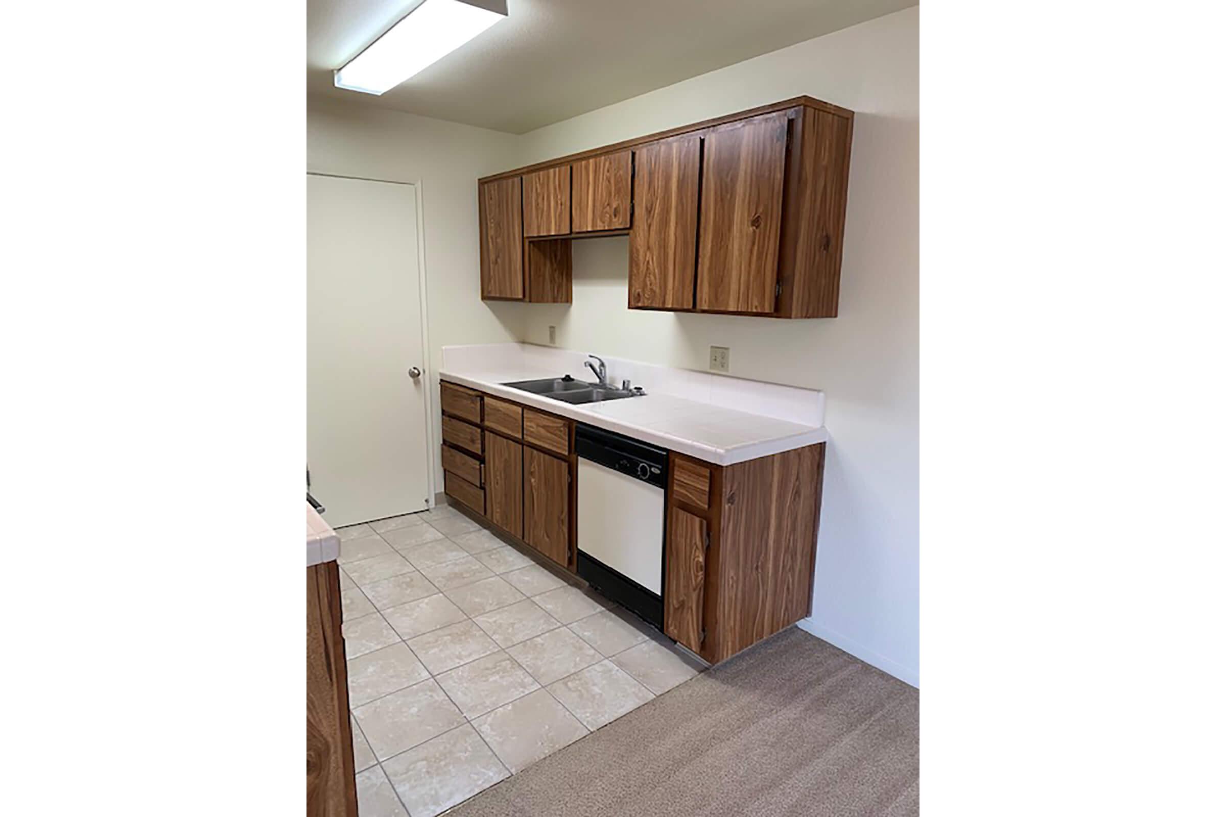 a kitchen with wooden cabinets