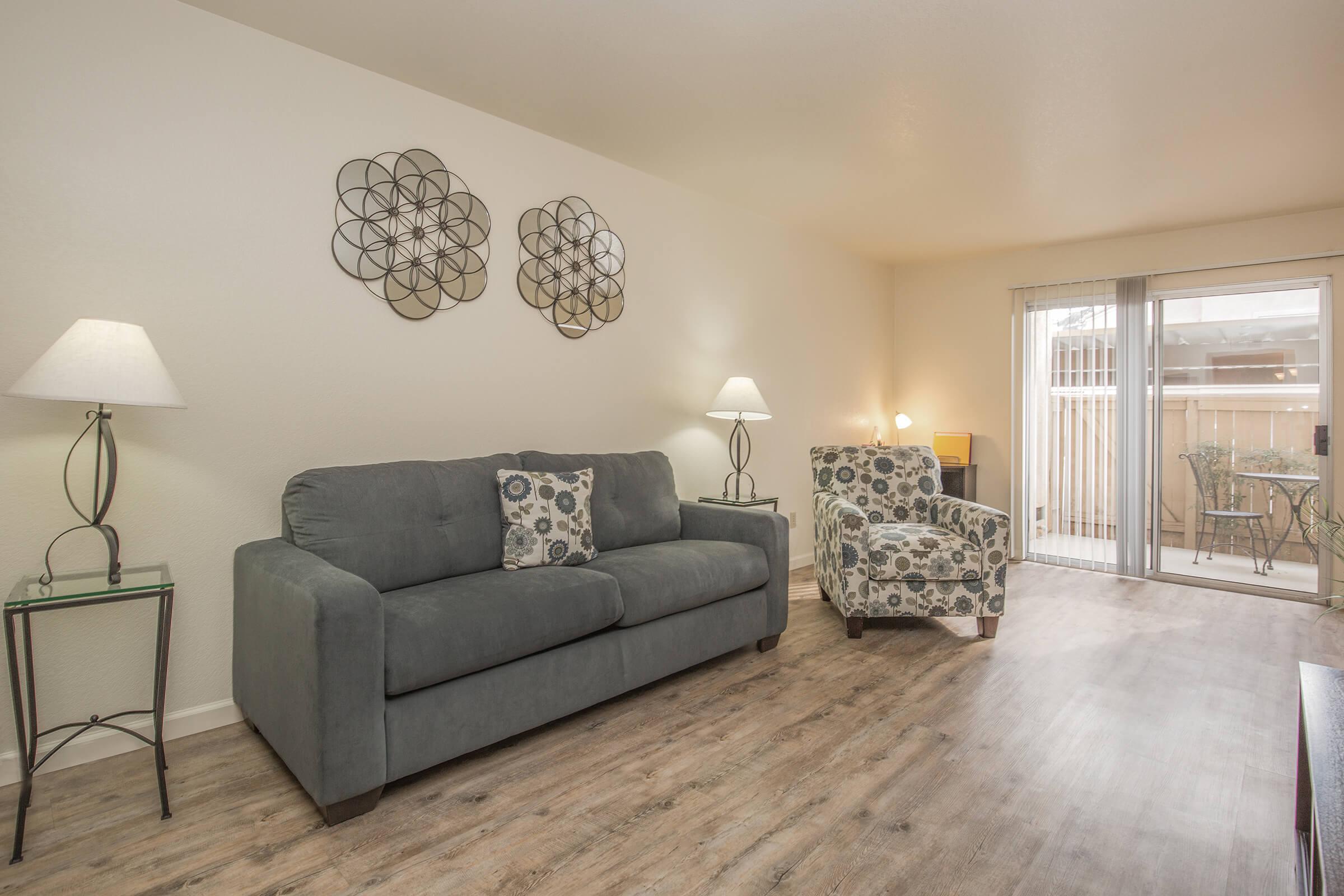 a living room filled with furniture and a lamp