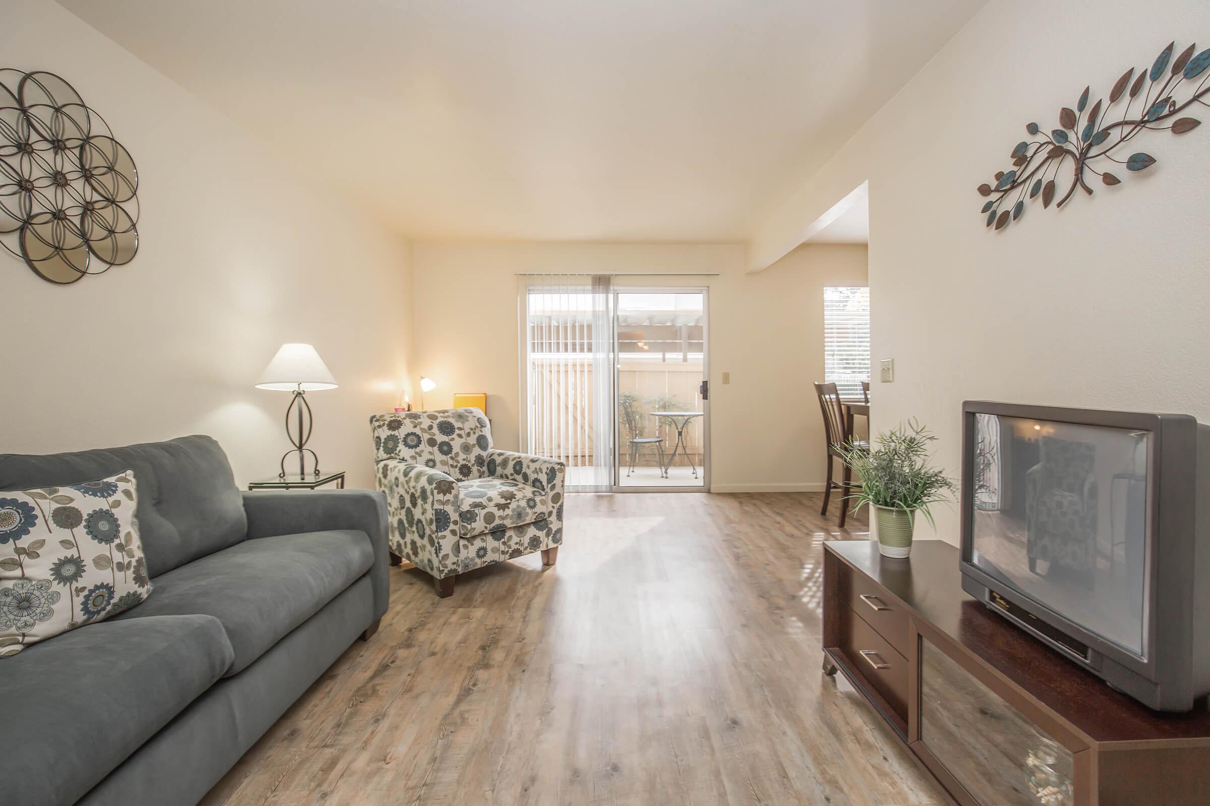 a living room filled with furniture and a flat screen tv