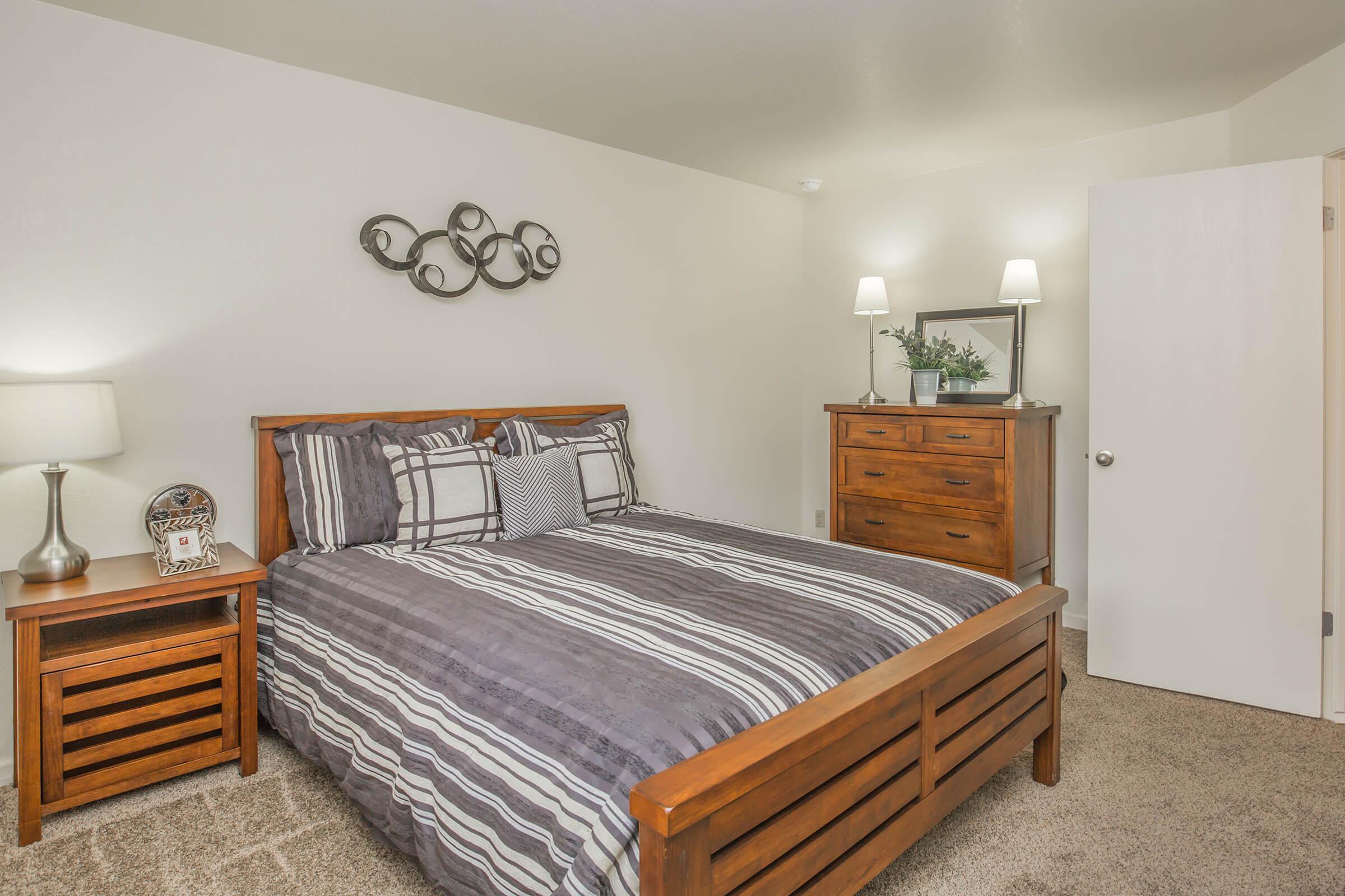 a bedroom with a bed and desk in a small room