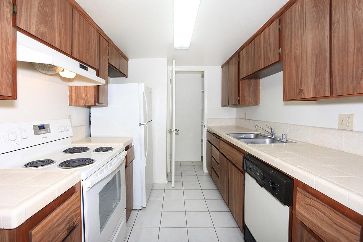 a kitchen with a stove sink and refrigerator