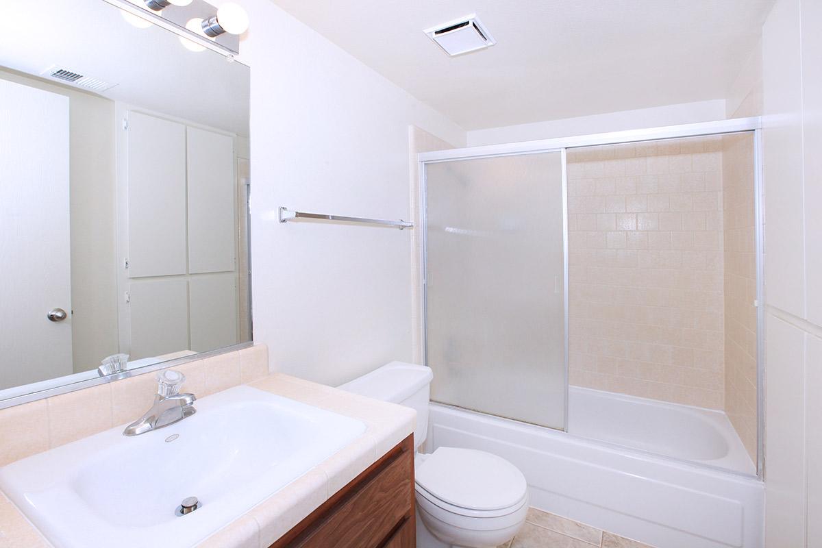 a white tub sitting next to a sink