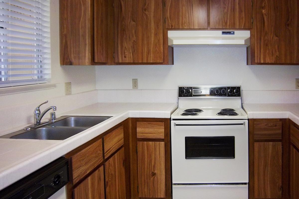 a white stove top oven sitting inside of a kitchen