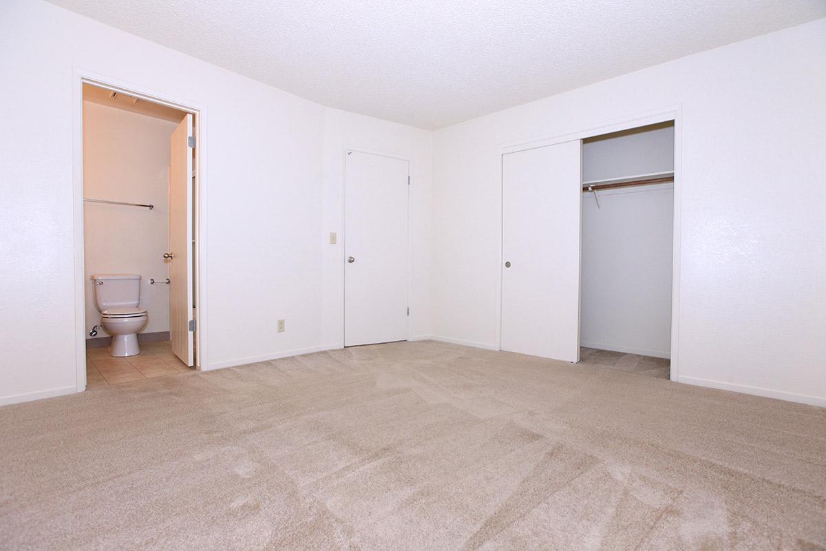 a bedroom with a wooden floor