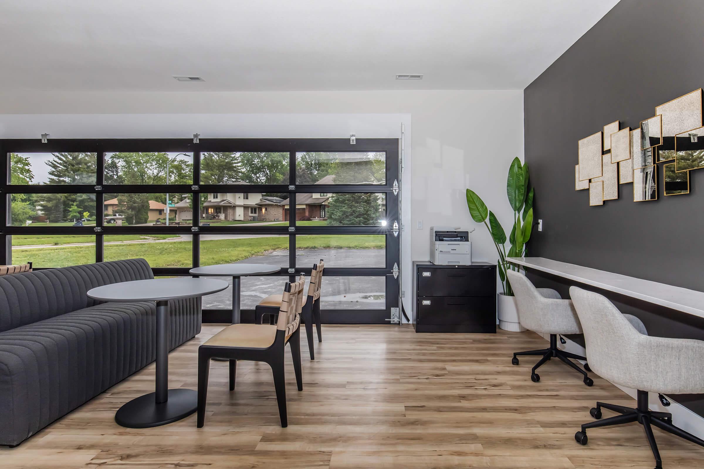 Co-working lounge and business center with modern seating and large windows at Bexley Urbandale.
