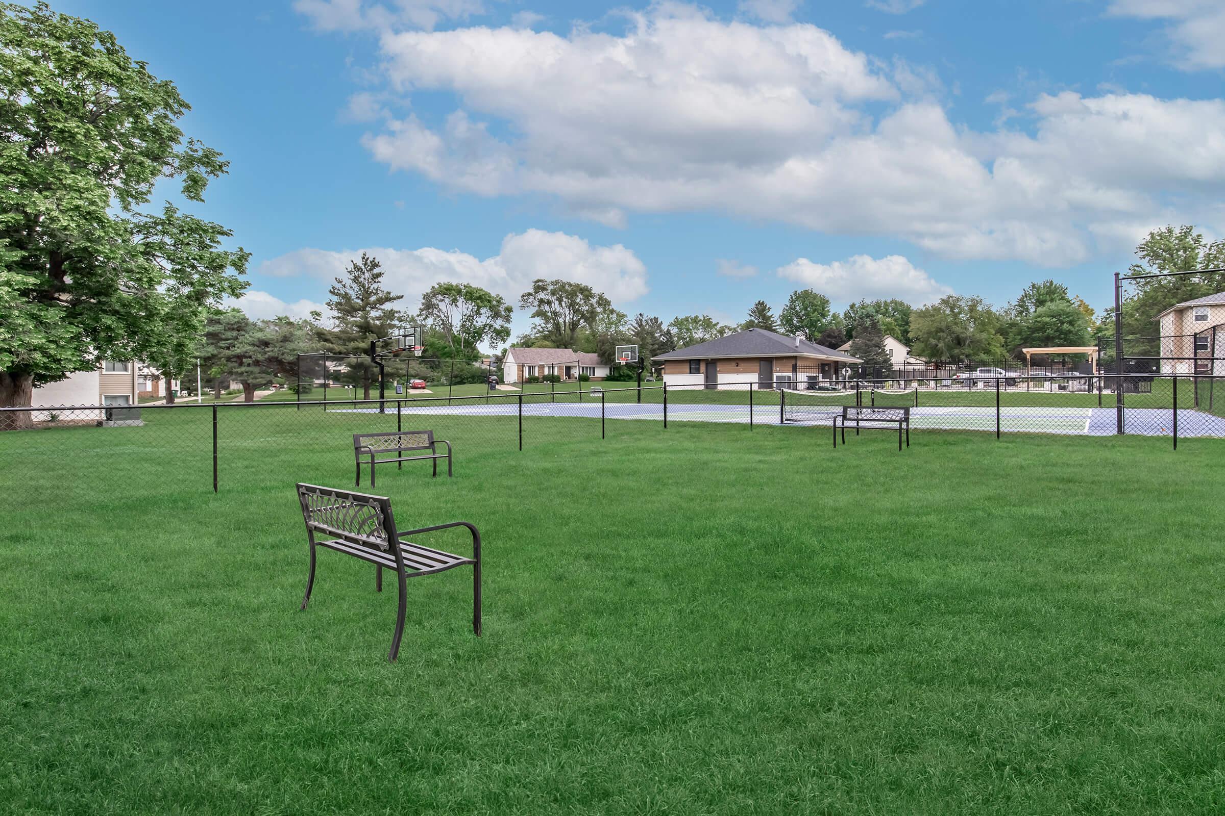 Open green space with benches, perfect for pets and outdoor recreation at Bexley Urbandale.