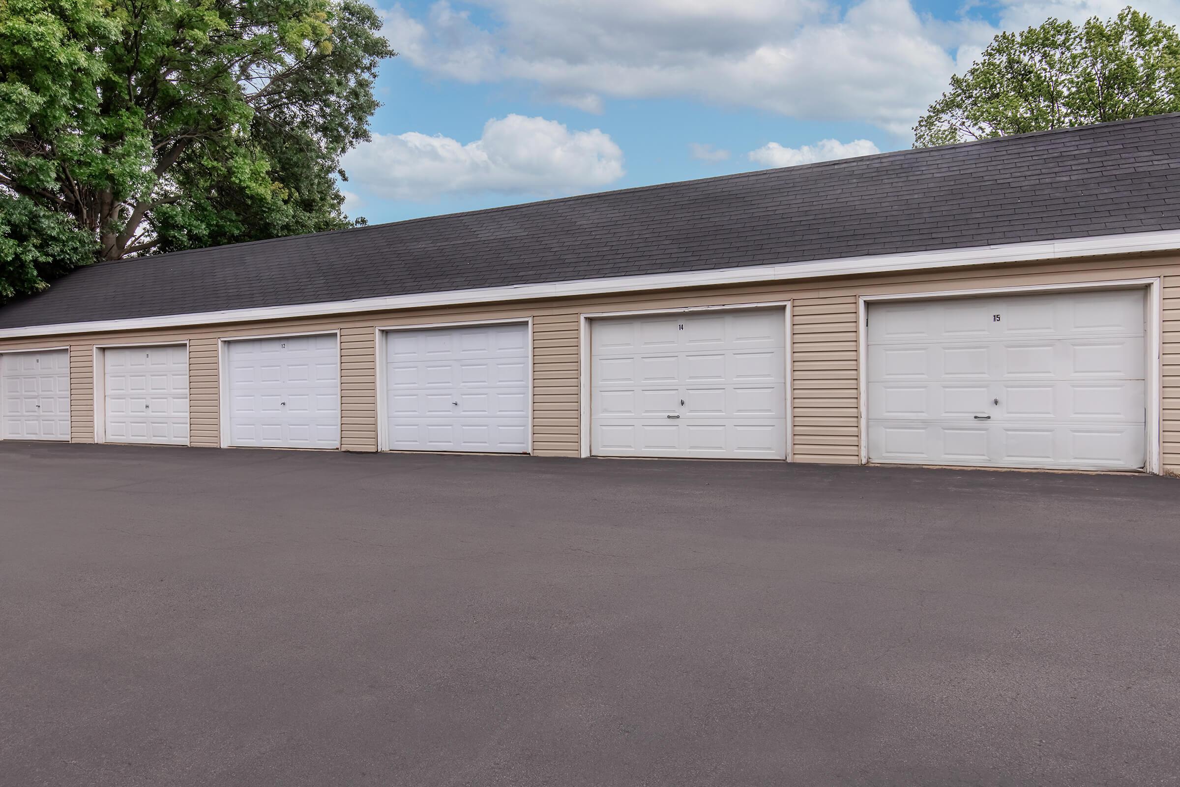 Row of private garages at Bexley Apartments, available for resident parking in Urbandale.