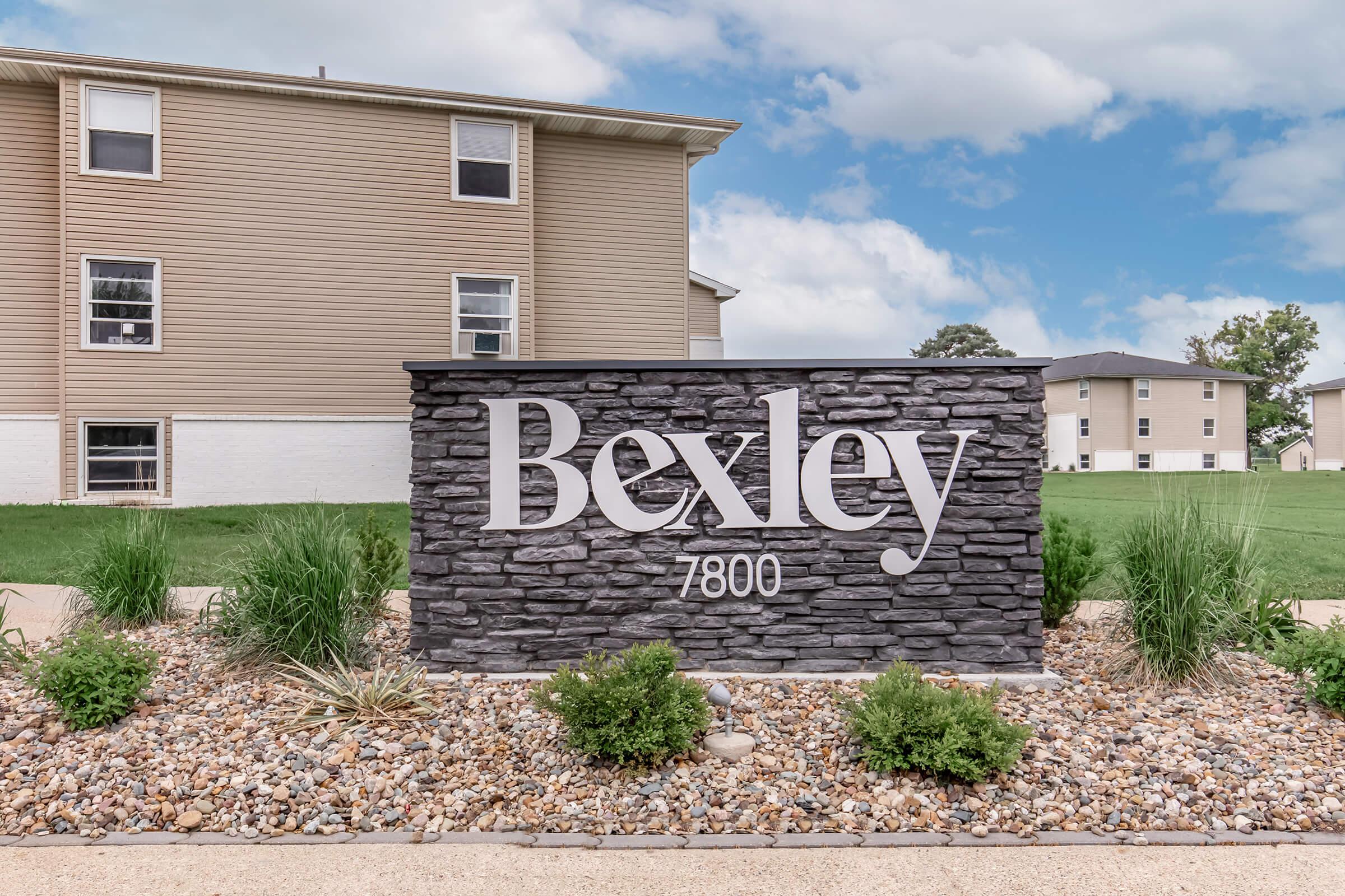 Bexley monument sign with landscaping in front of renovated apartments in Urbandale, IA.