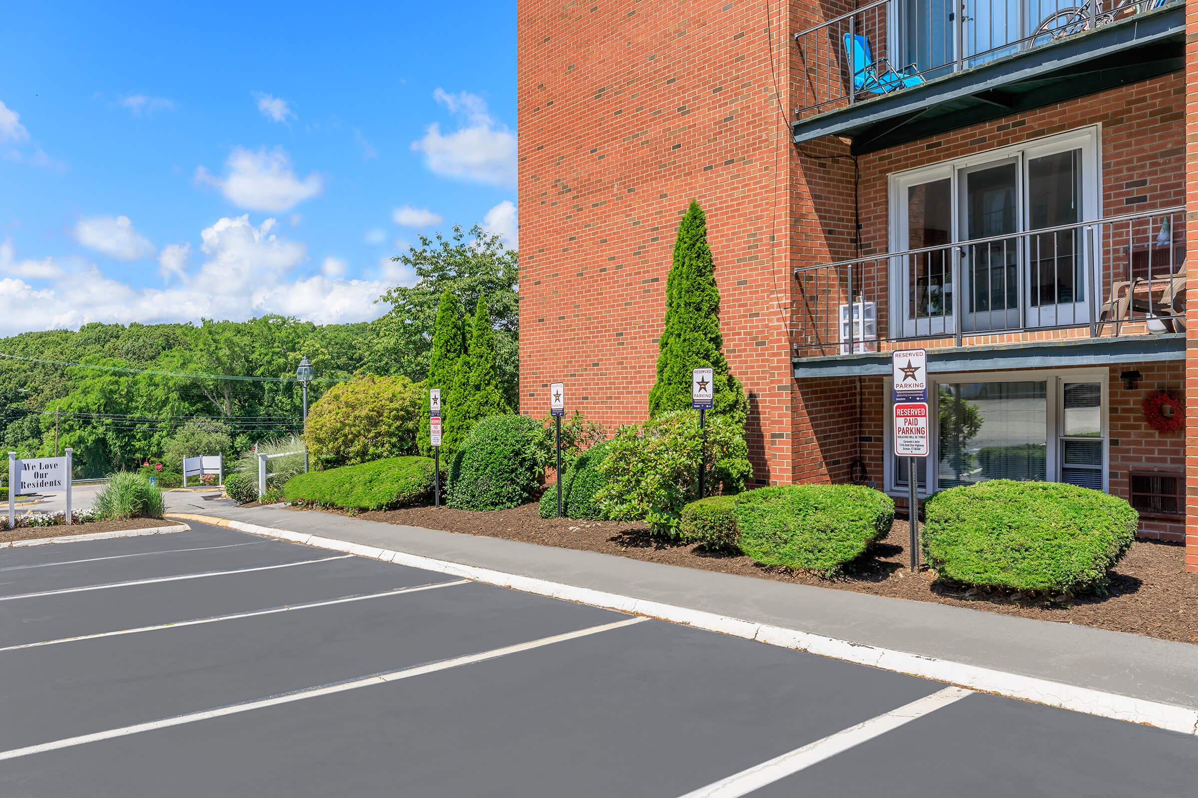 an empty road in front of a brick building