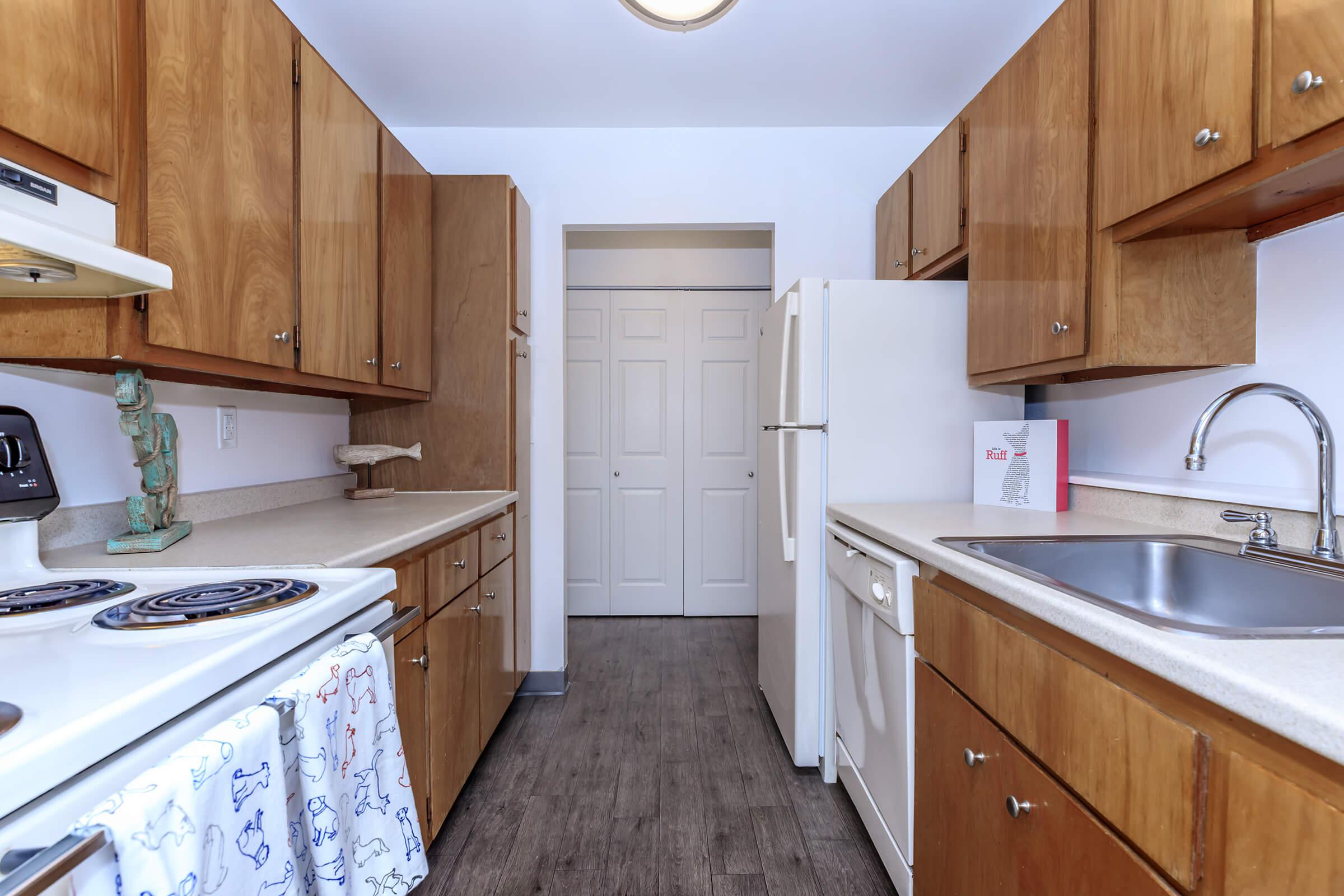 a kitchen with stainless steel appliances and wooden cabinets