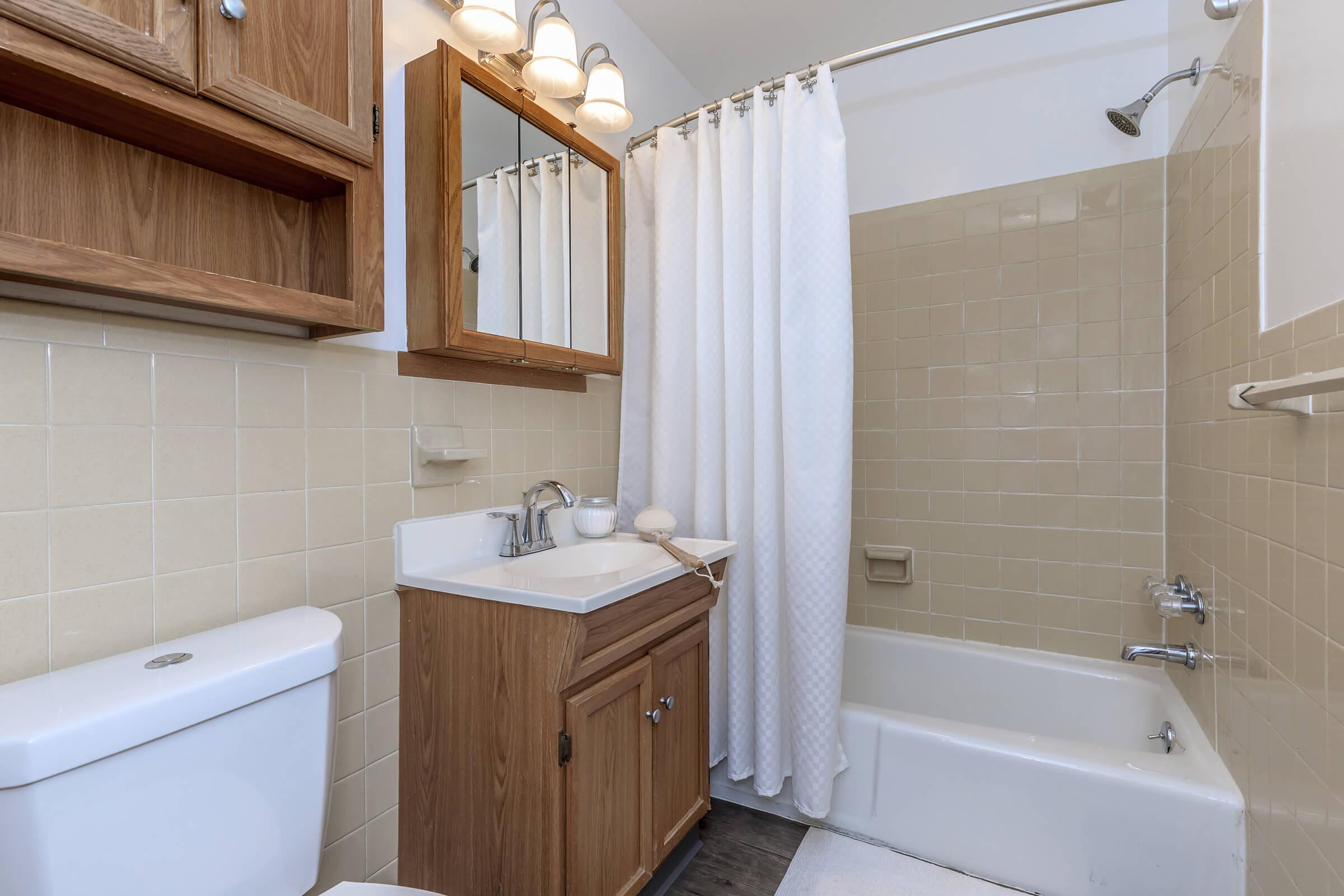 a white tub sitting next to a sink