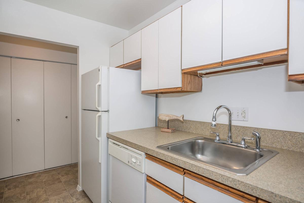 a kitchen with a sink and a mirror