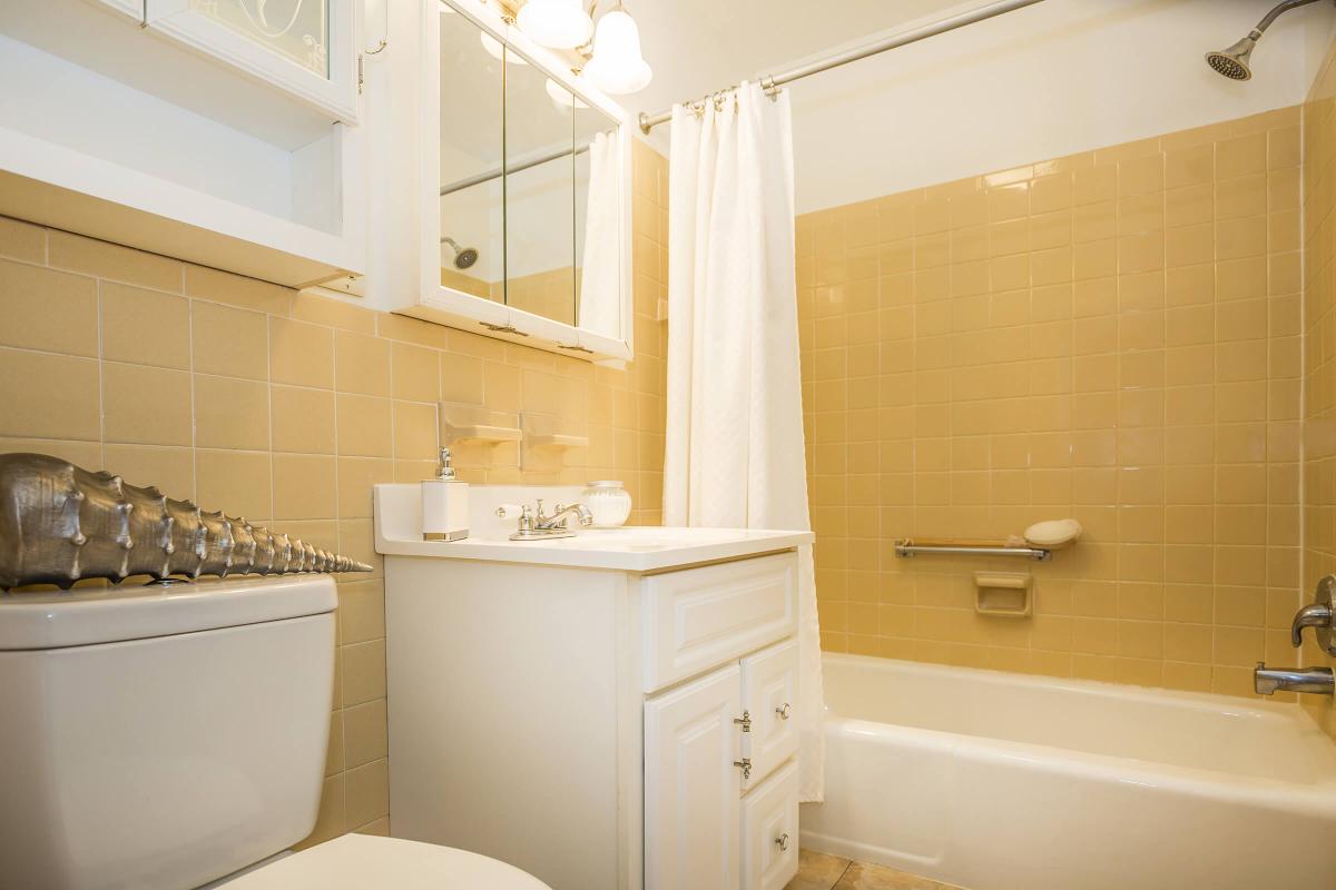 a white tub sitting next to a sink