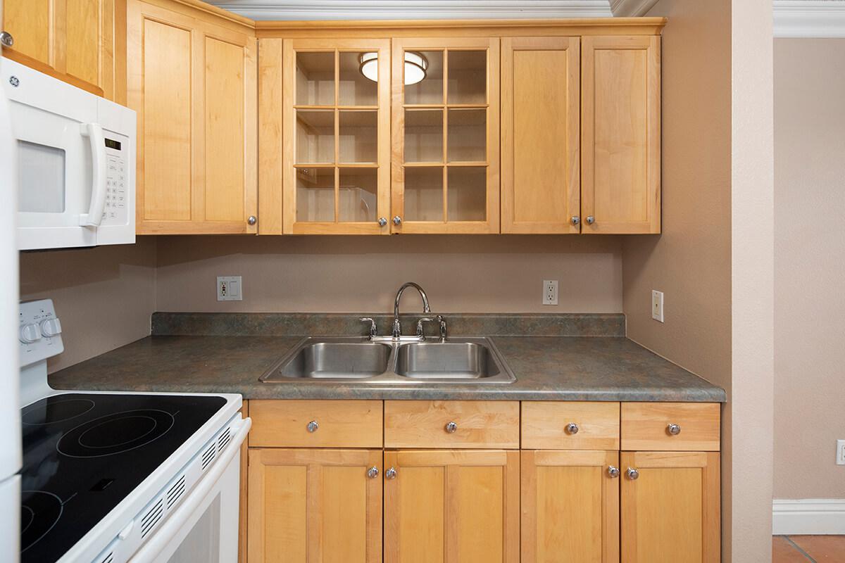 a kitchen with a stove a sink and a microwave