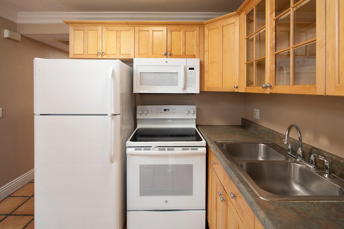 a stove top oven sitting inside of a kitchen