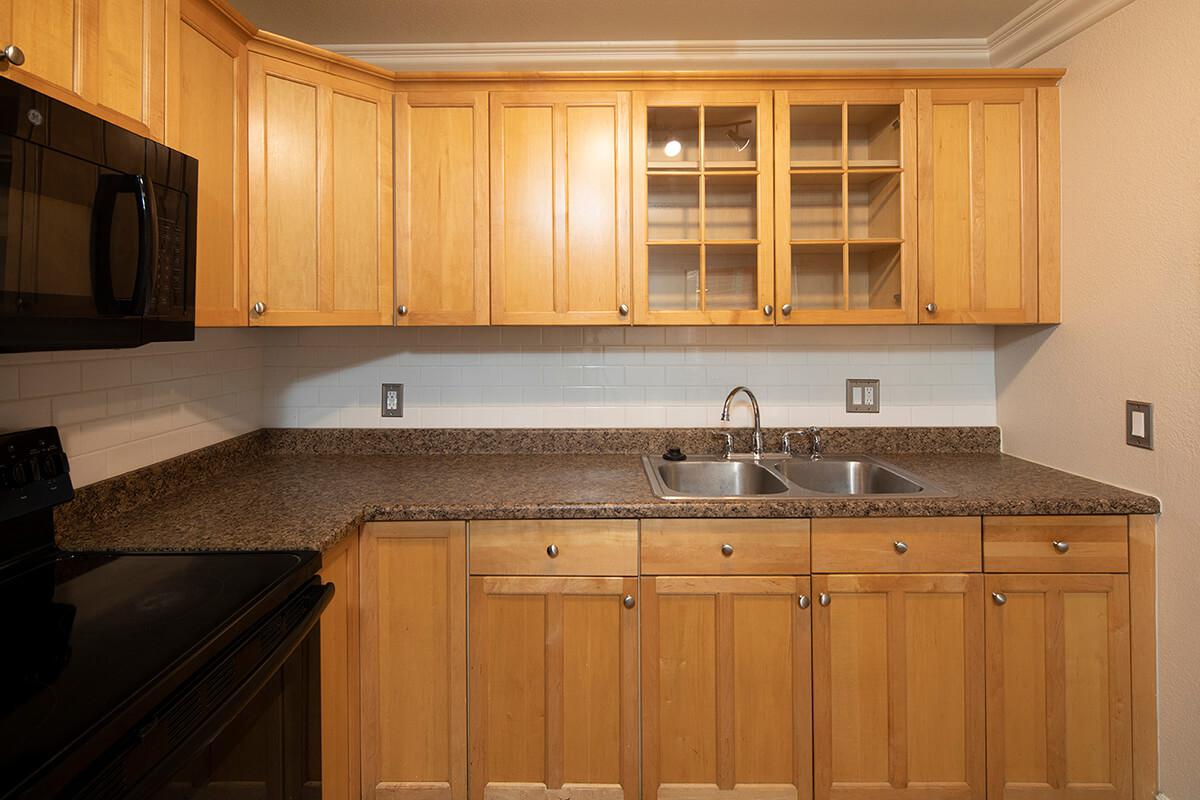 a kitchen with stainless steel appliances and wooden cabinets