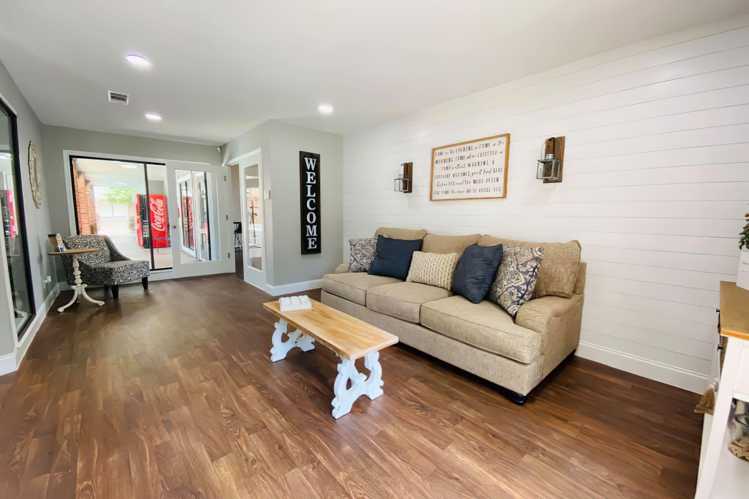 a living room filled with furniture on top of a hard wood floor