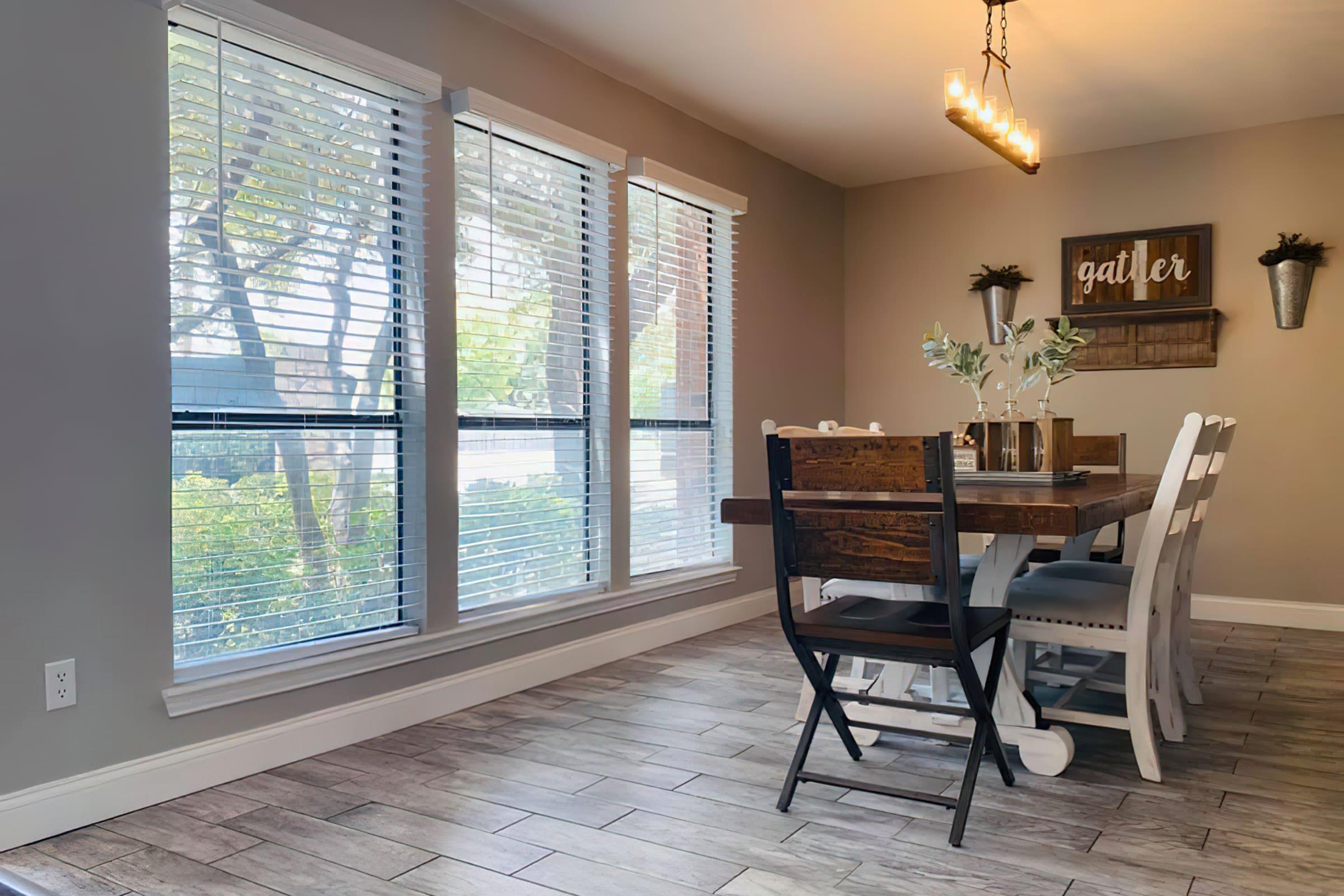 a dining room table in front of a window