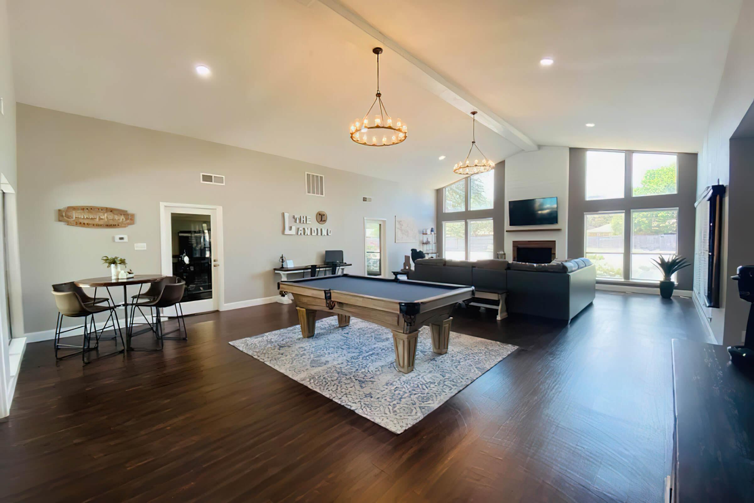 a living room filled with furniture and a wood floor