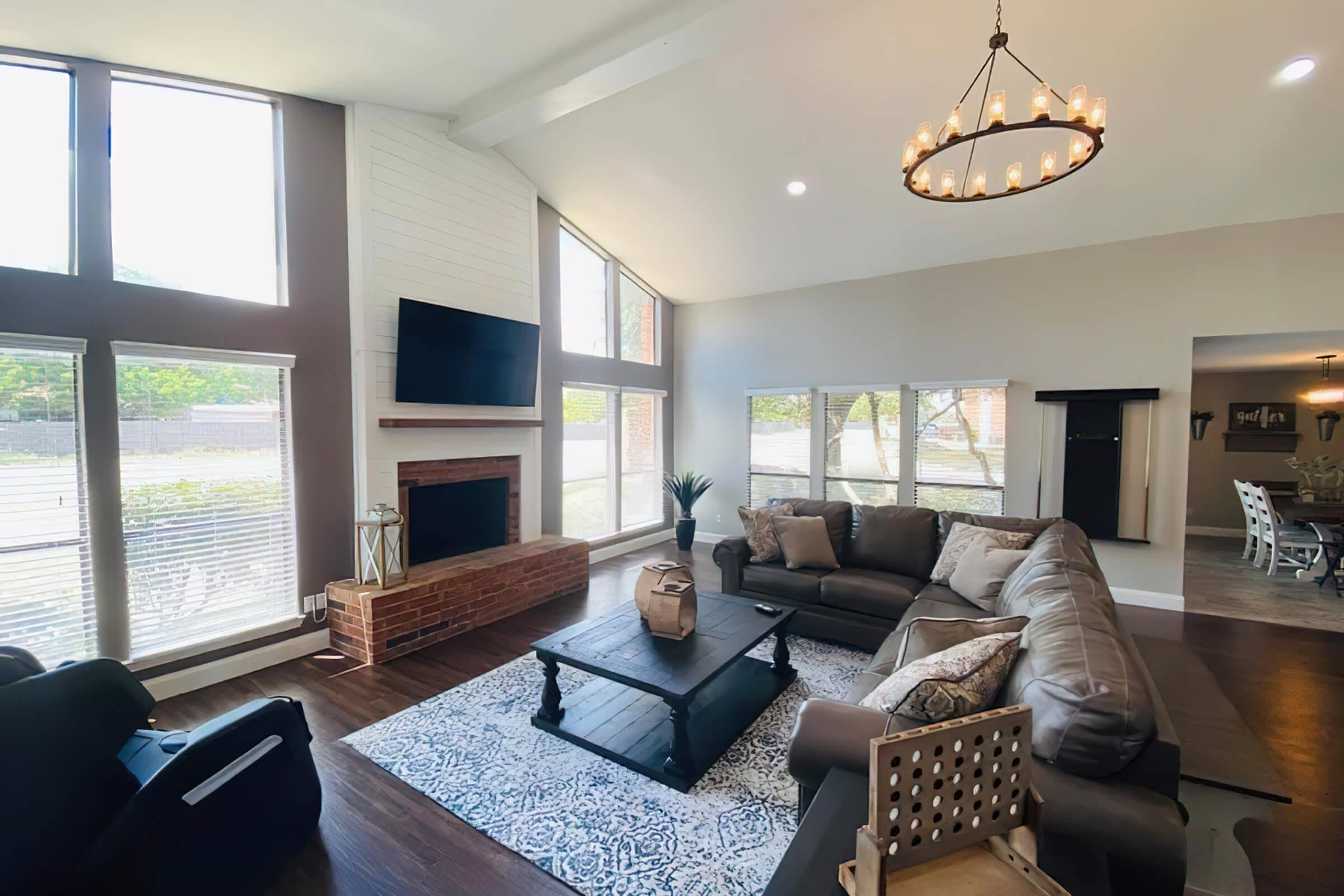 a living room filled with furniture and a large window