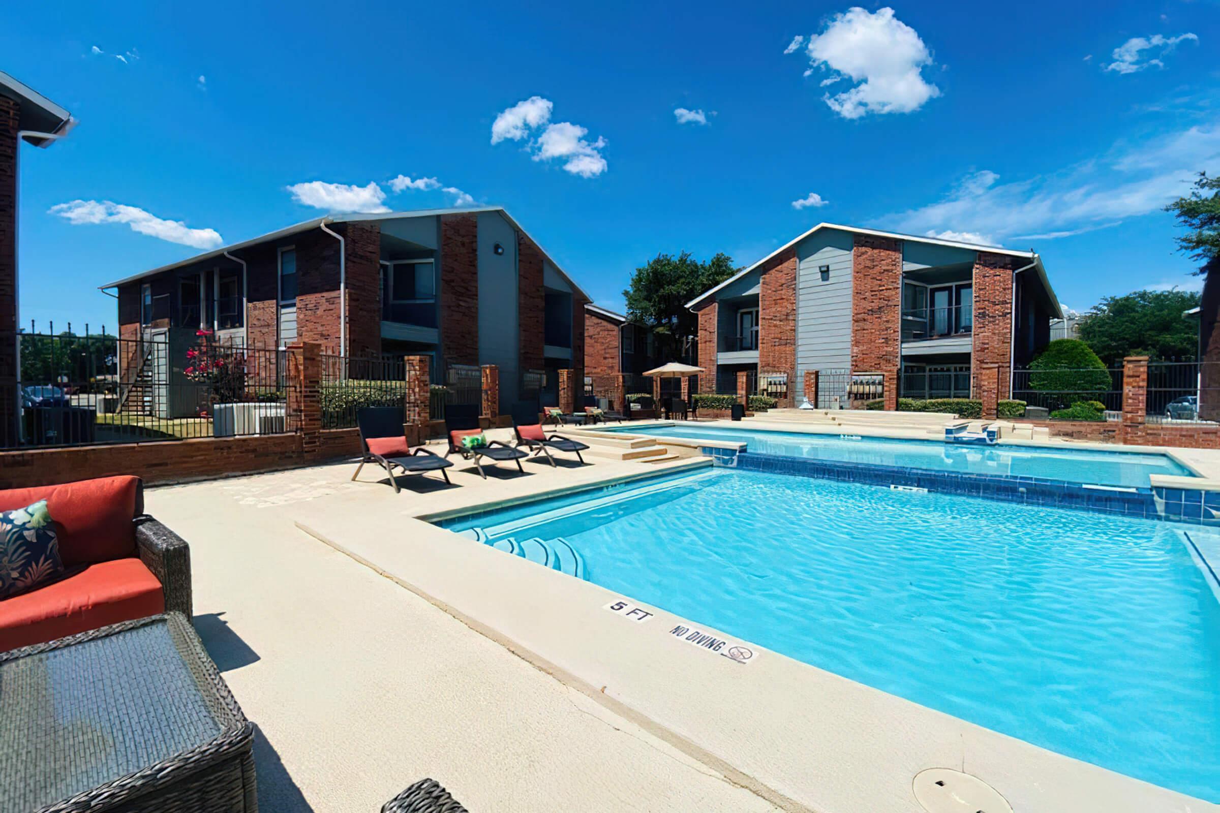 a house with a pool outside of a building