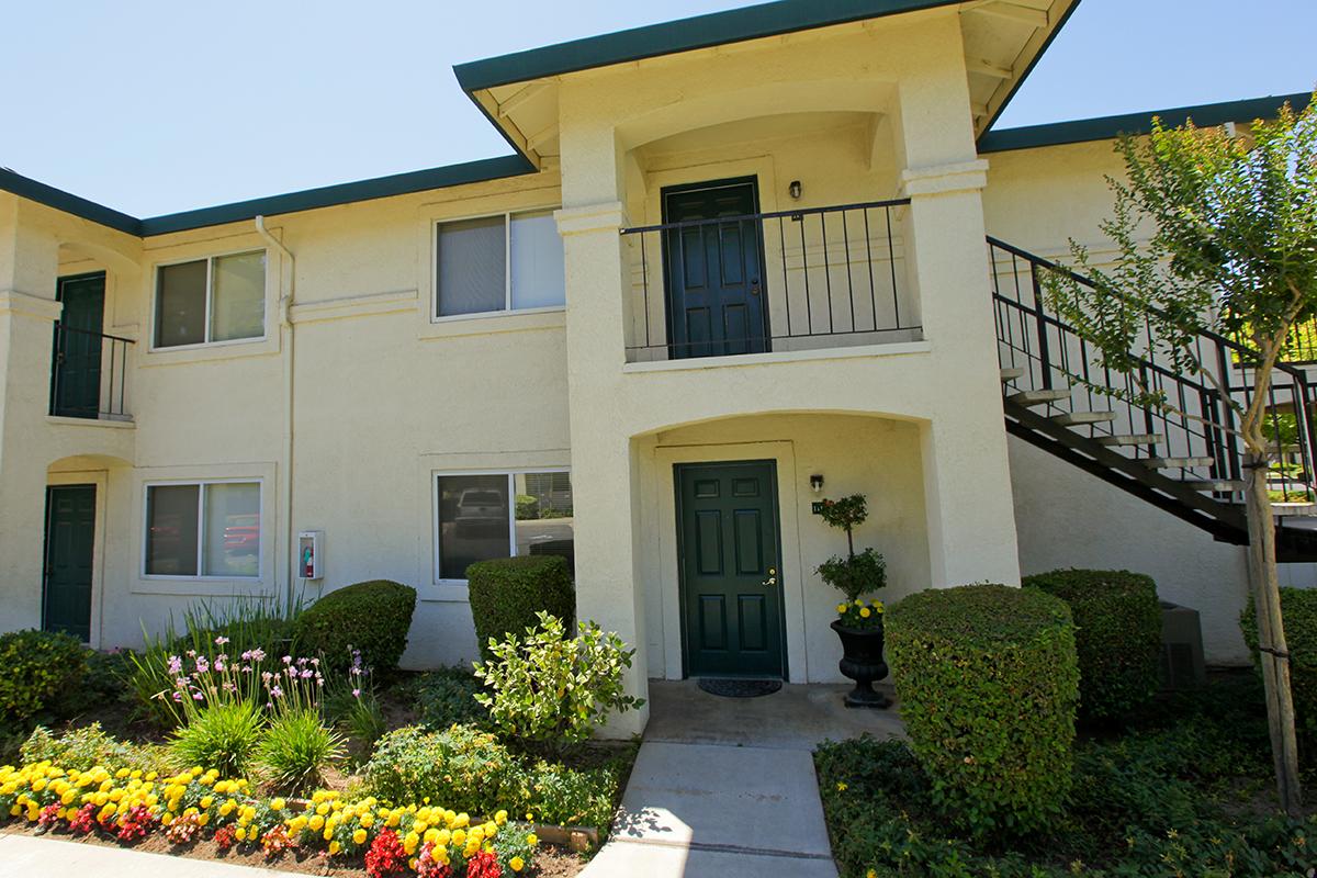 a house with bushes in front of a building