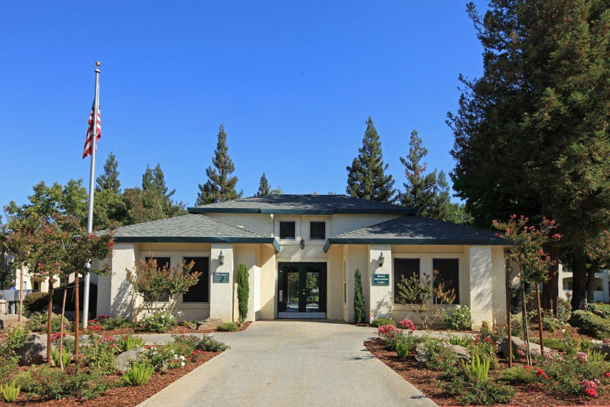 a house with bushes in front of a building