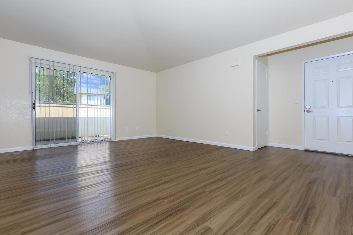 a large empty room with a wood floor