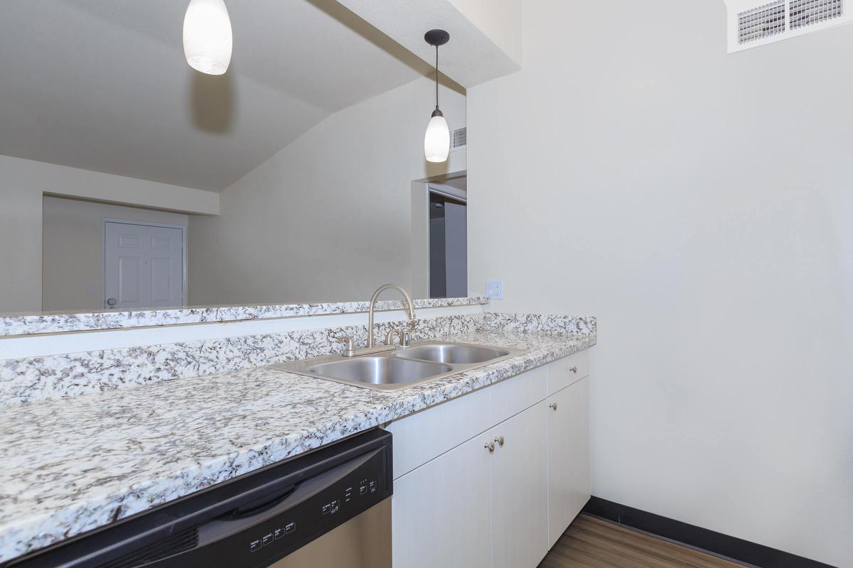 a kitchen with a sink and a mirror