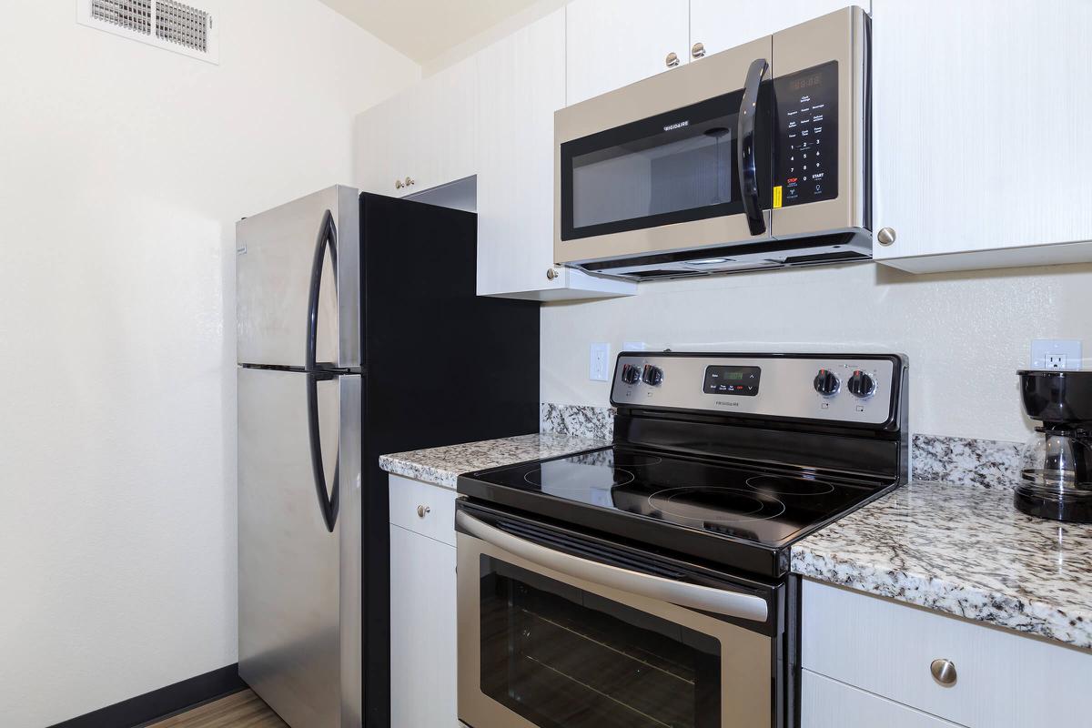 a stove top oven sitting inside of a kitchen