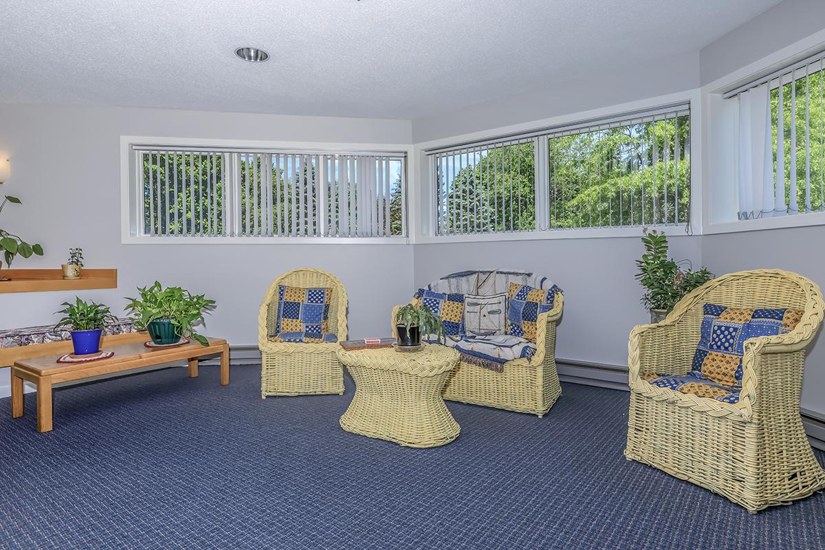 a living room filled with furniture and a large window