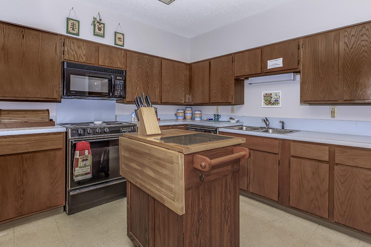 a kitchen with stainless steel appliances and wooden cabinets