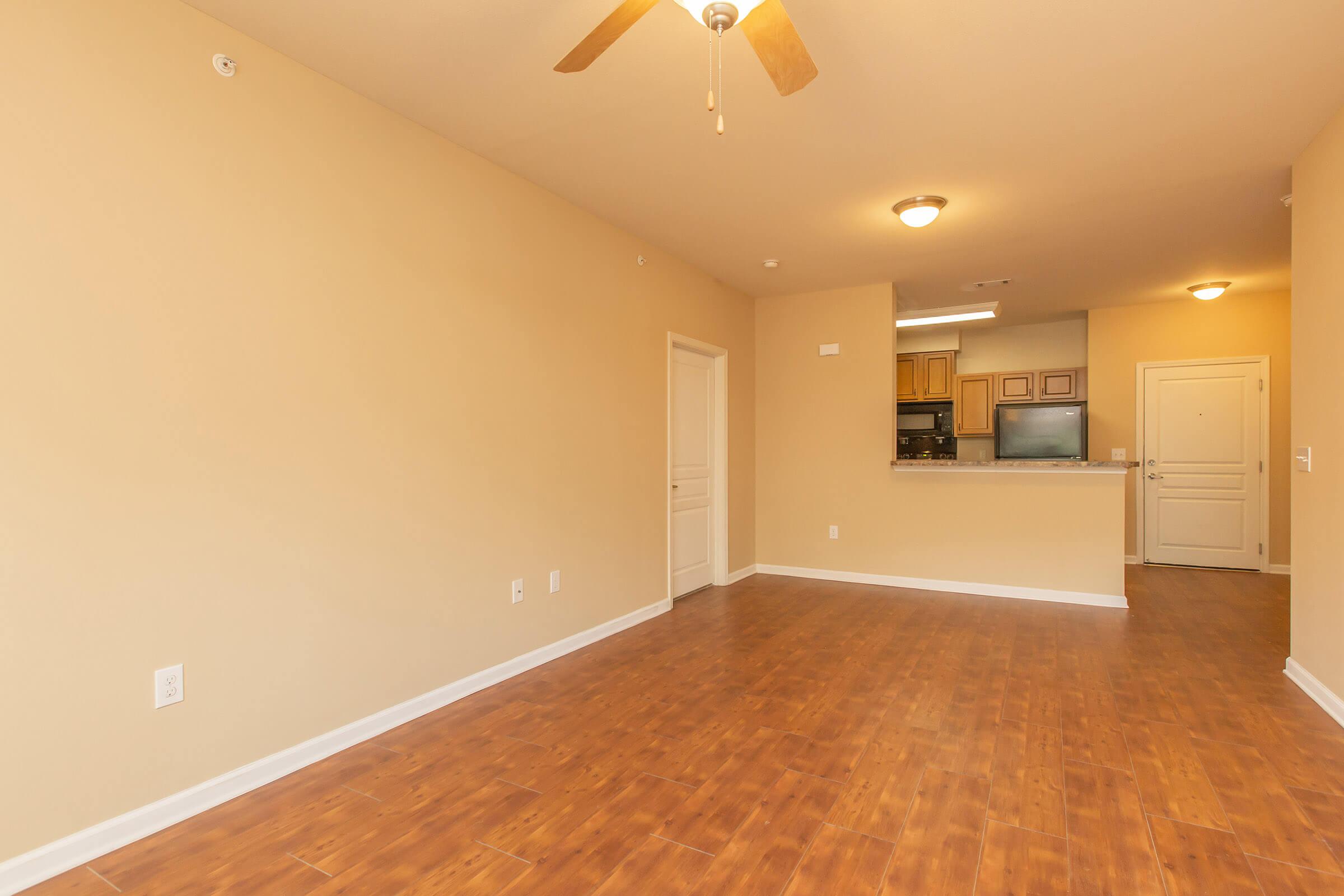 a large empty room with a wood floor