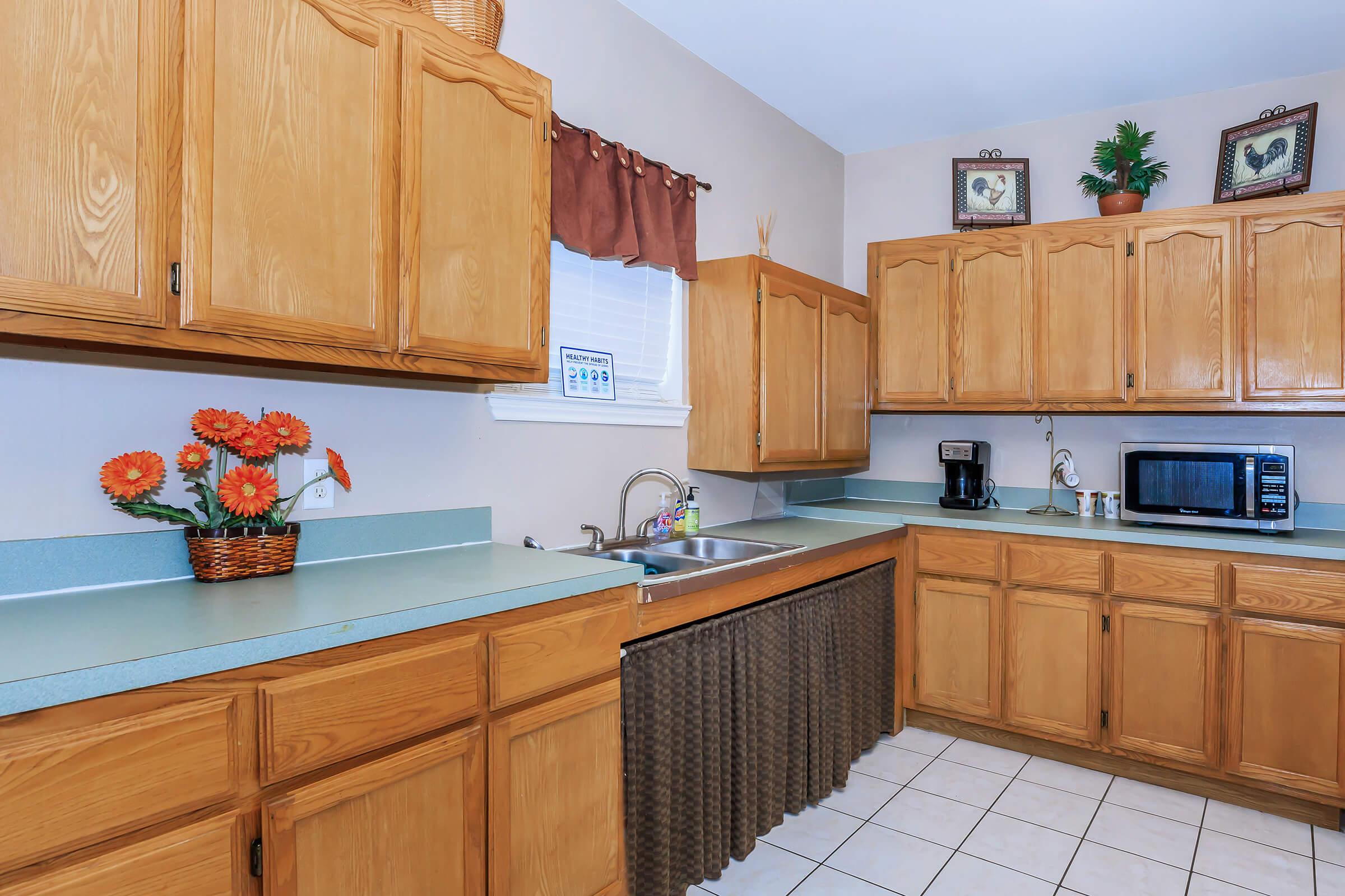 a kitchen with wooden cabinets