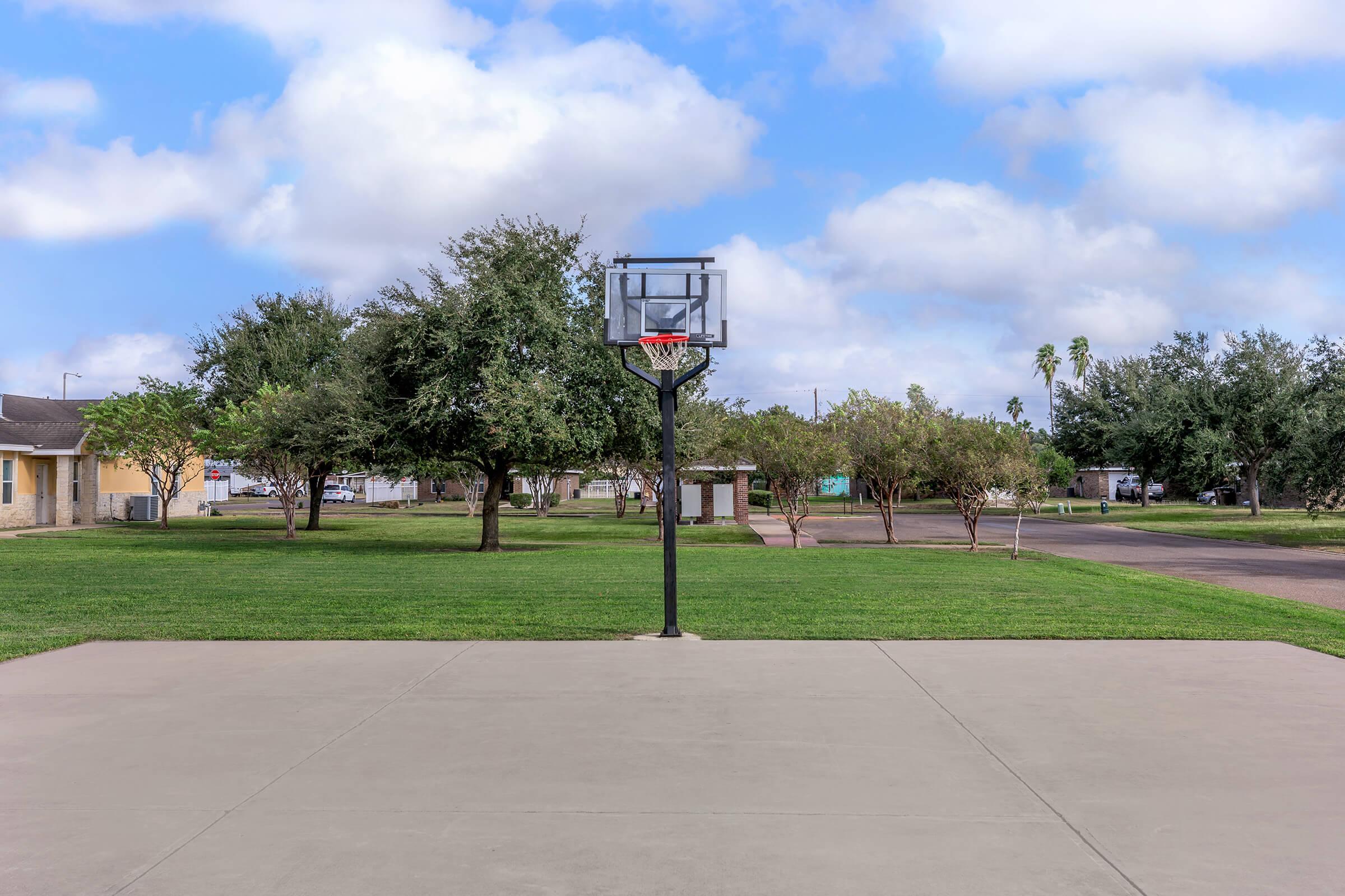 a basketball hoop on the side of a road