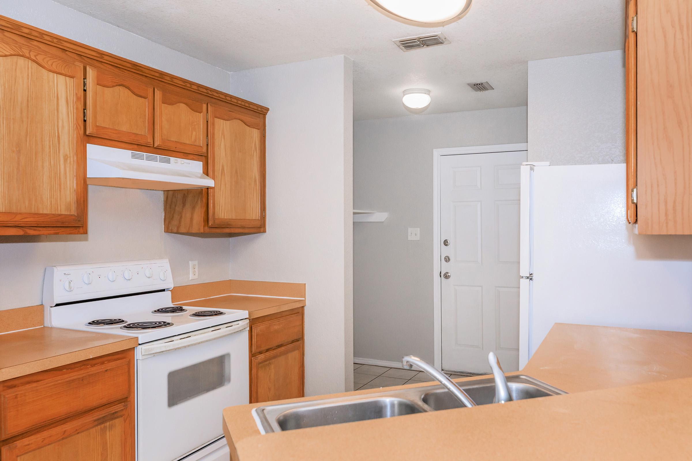 a kitchen with wooden cabinets and a microwave