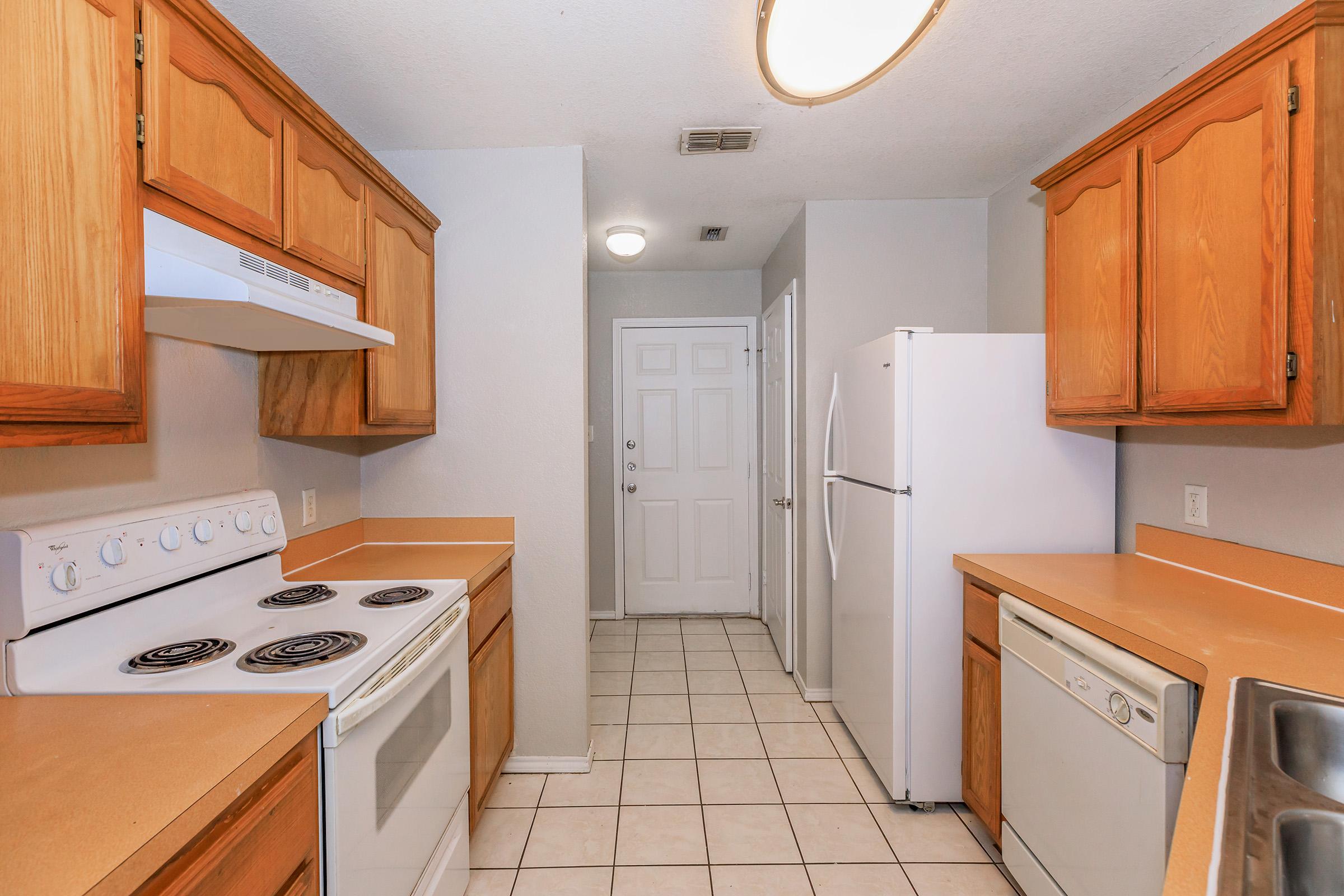 a kitchen with a stove and a refrigerator