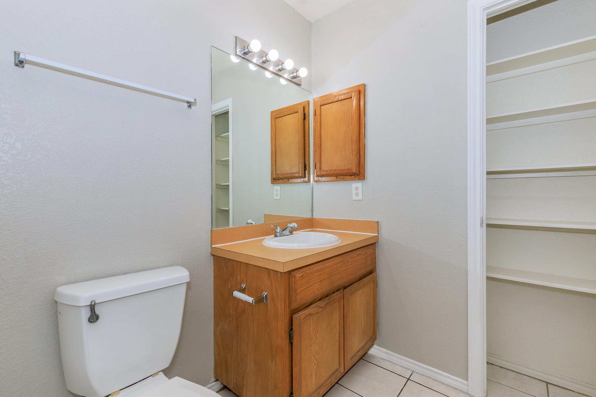 a room with a sink and a mirror