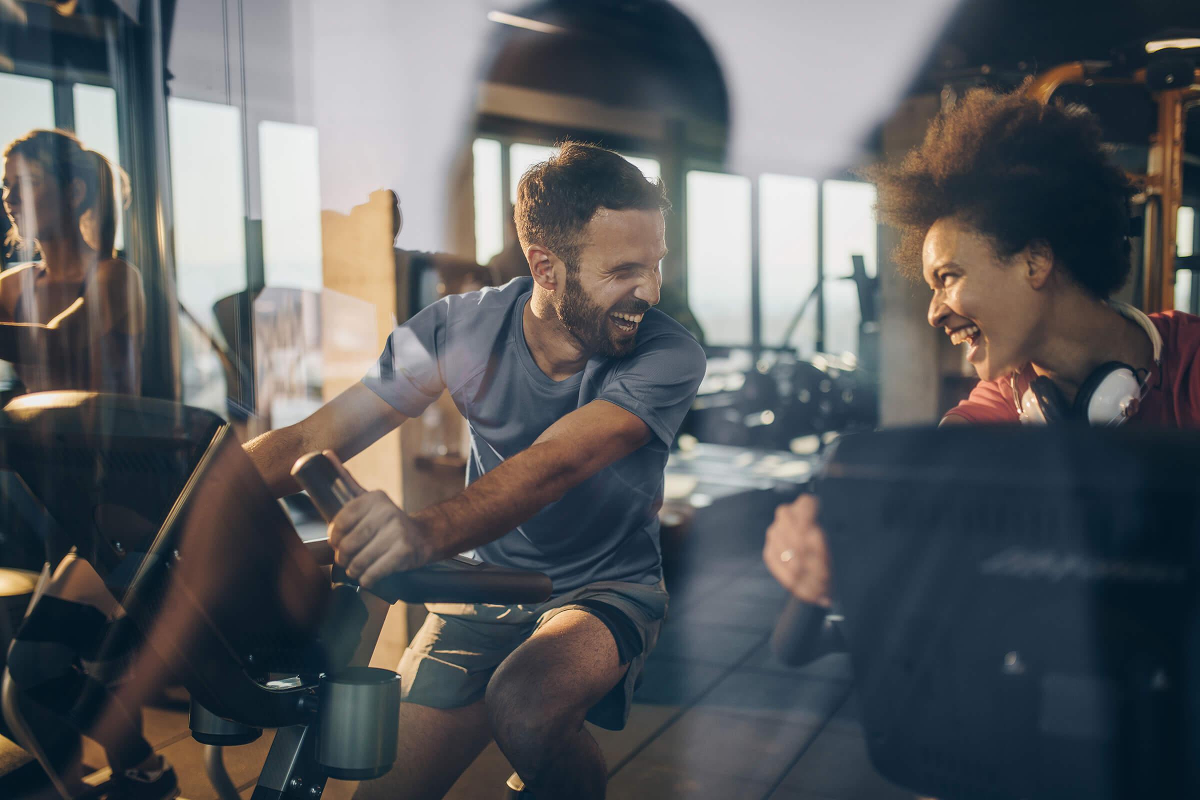 Happy athletes communicating and laughing while exercising in a gym together. iStock-860866680.jpg