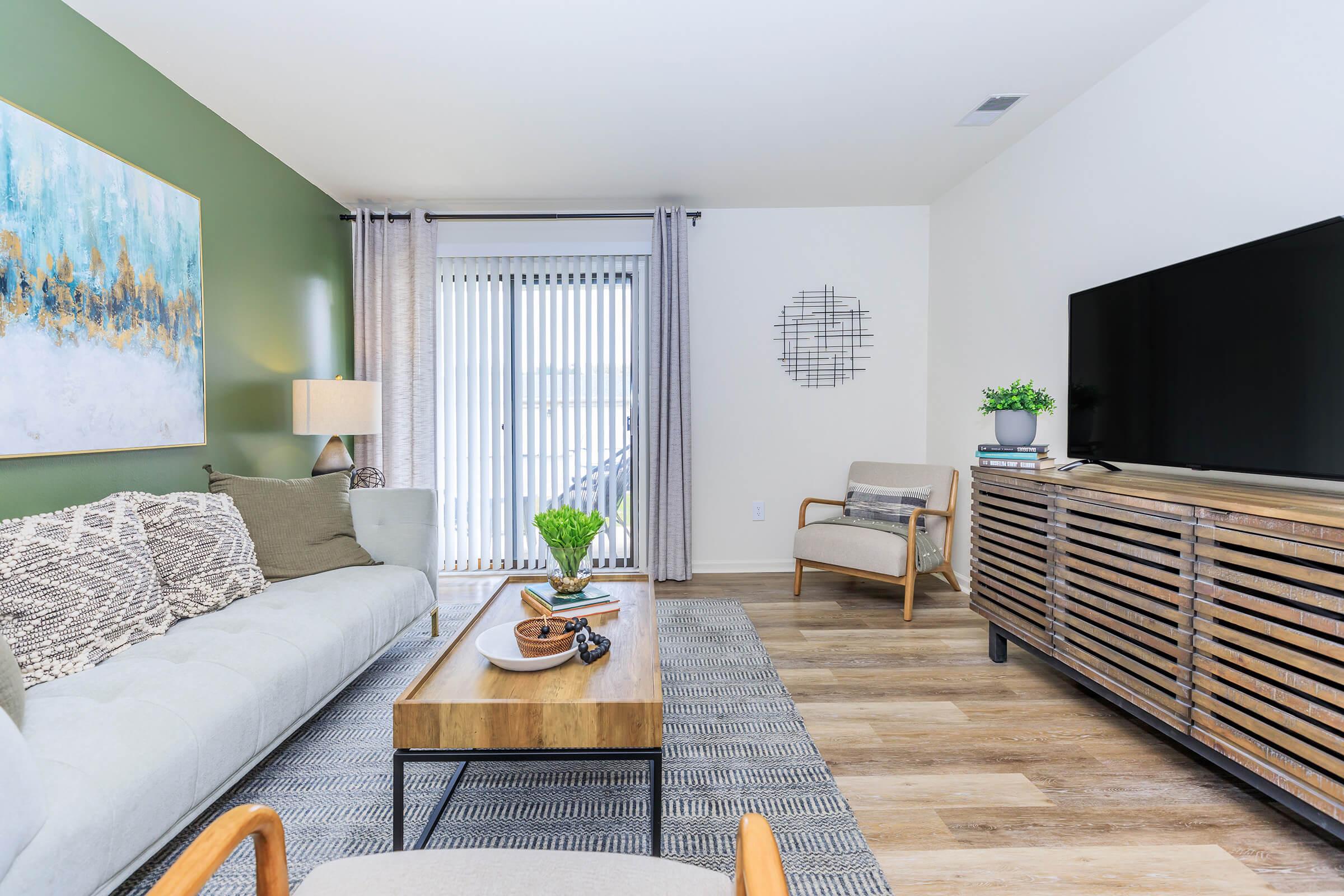 a living room filled with furniture and a large window