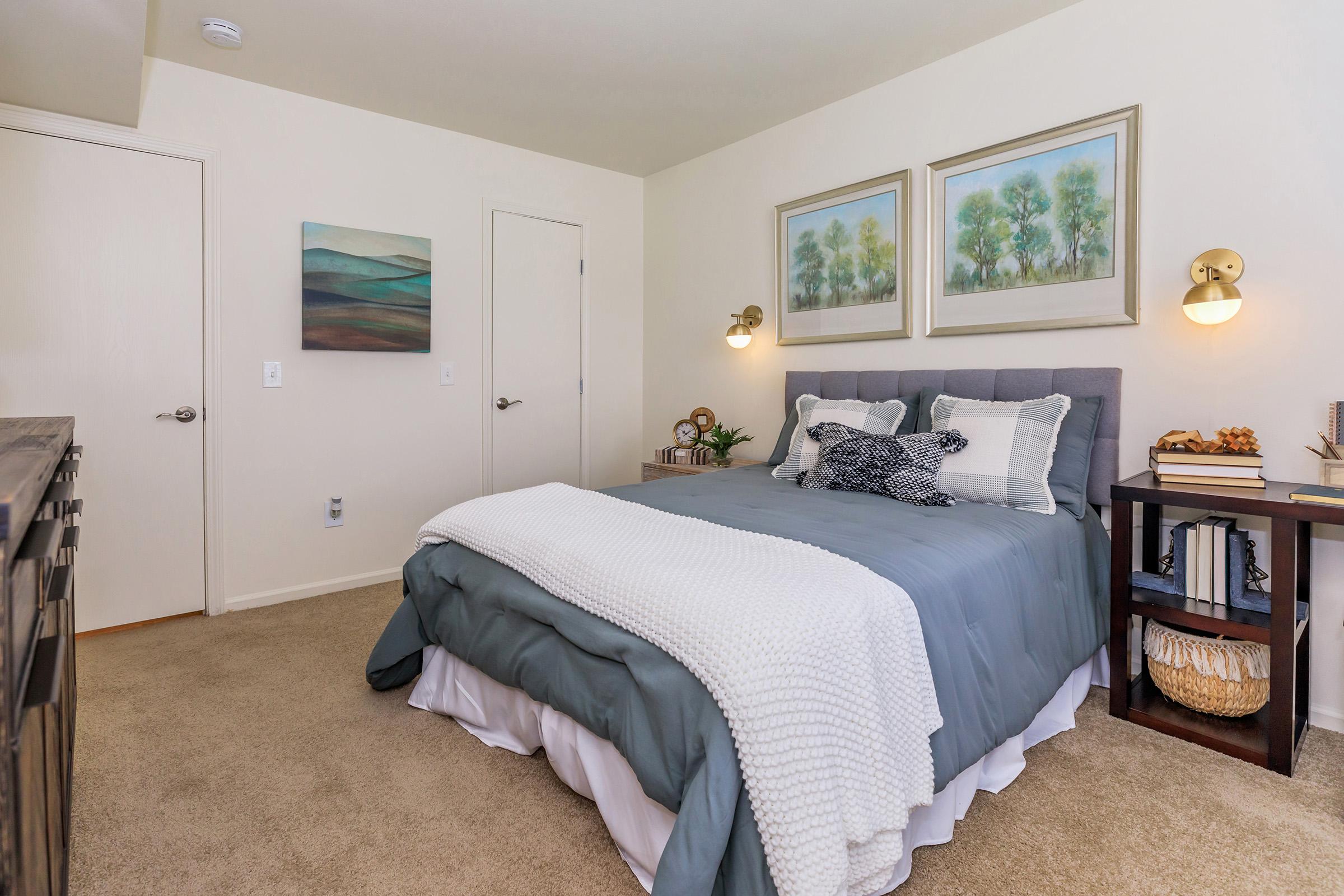 a bedroom with a bed and desk in a room