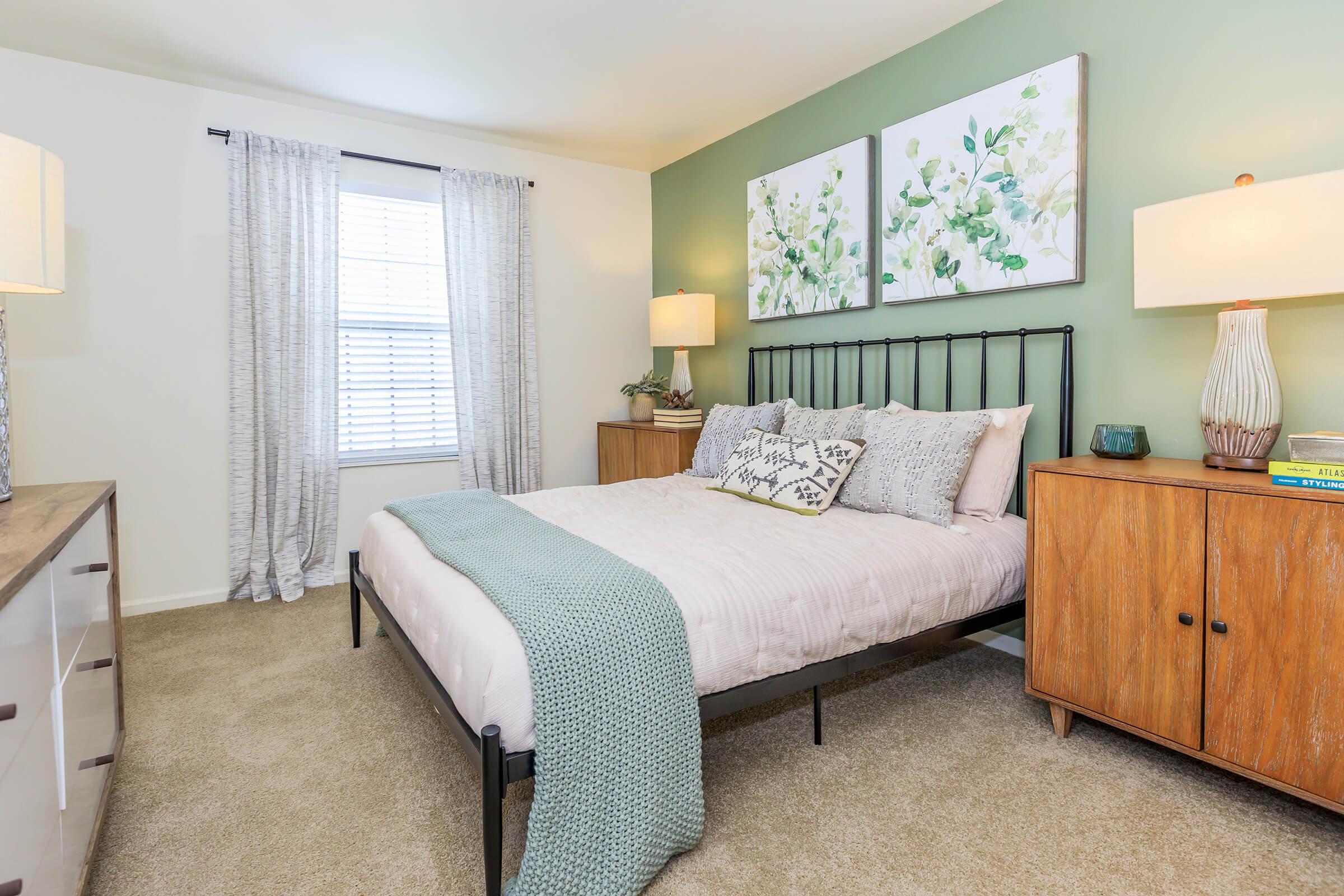 a bedroom with a bed and desk in a room